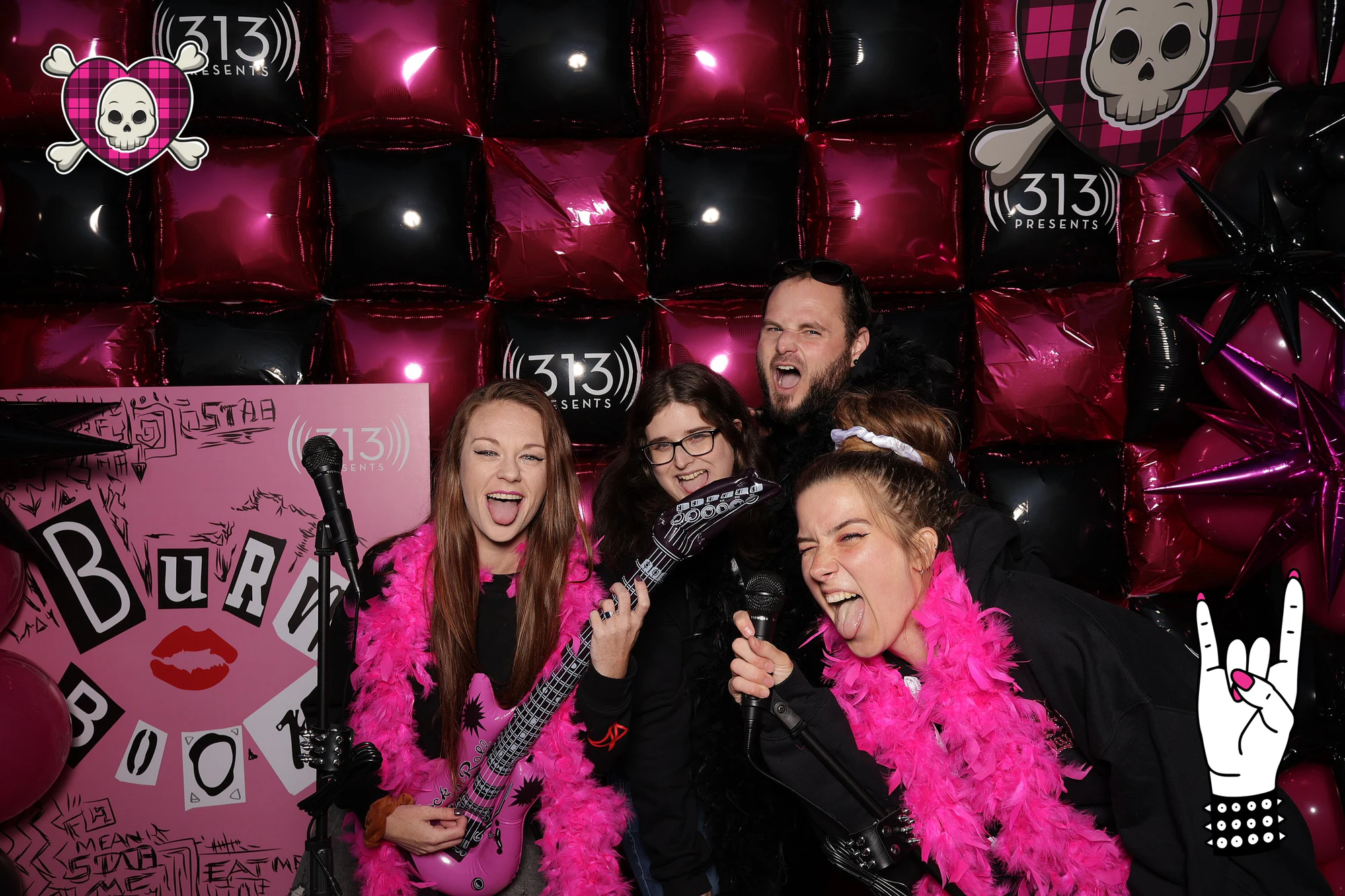 Four guests around the mic with a pink inflatable guitar and feather boas at Avril Lavigne VIP Party at Pine Knob