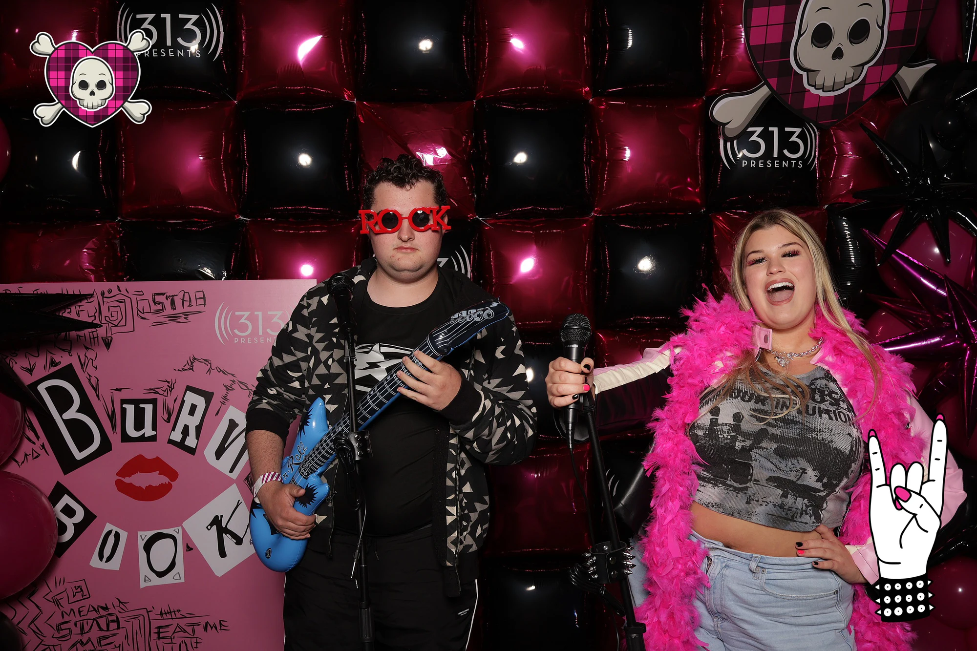 A guest in sunglasses with a blue inflatable guitar, another mid-shout at the mic in a boa at Avril Lavigne VIP Party at Pine Knob