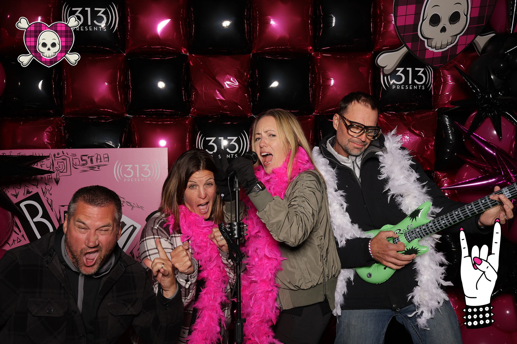 Four guests crowded around the mic stand, one on a green inflatable guitar at Avril Lavigne VIP Party at Pine Knob