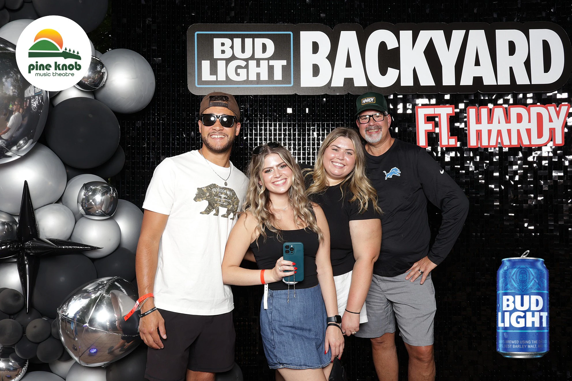 Four guests in front of the Bud Light Backyard sign and the balloon wall at Bud Light Tailgate with 313 Presents, 2025