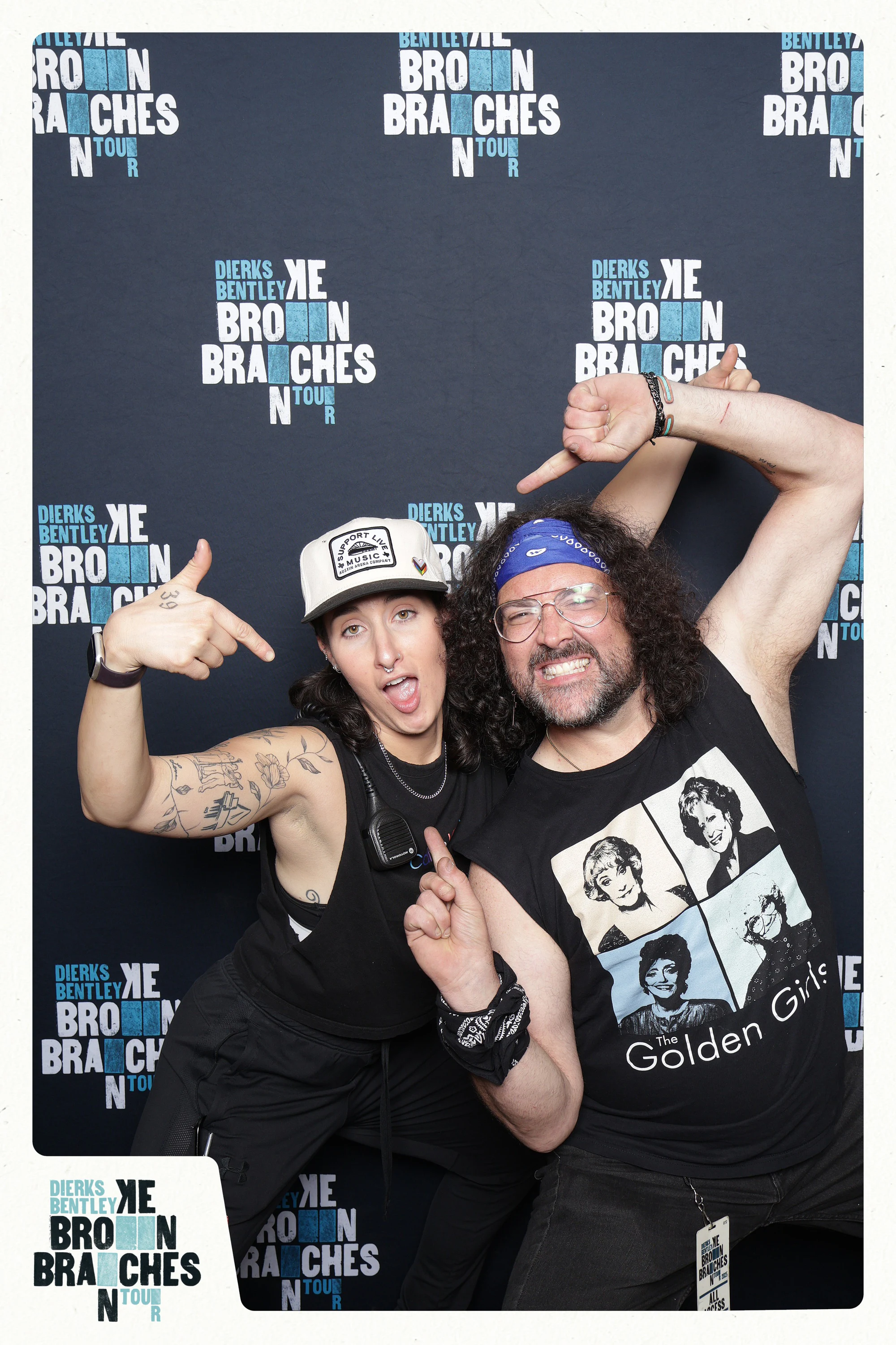 Two guests throwing finger guns at each other, one in a Golden Girls tee at Dierks Bentley End of Tour Party