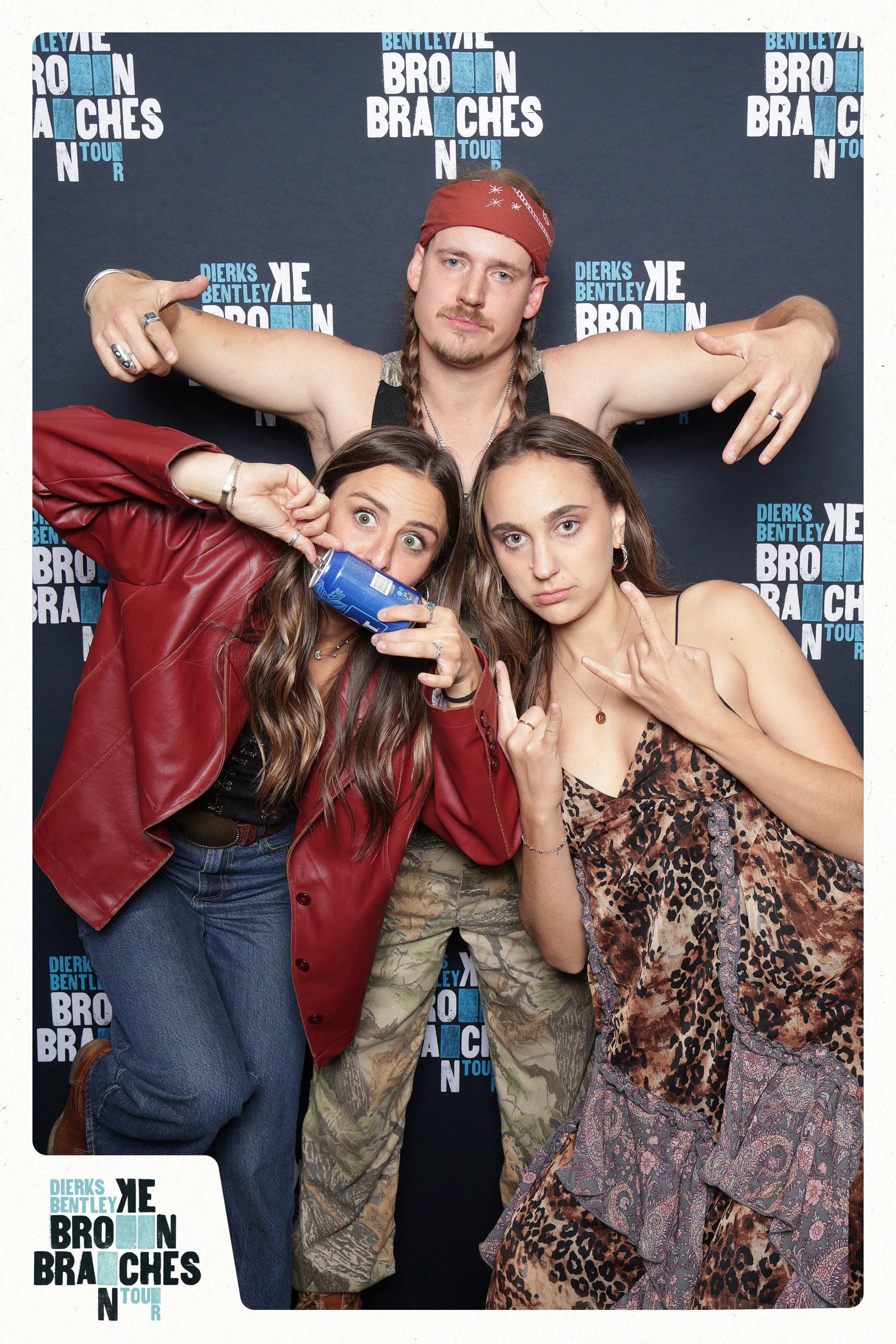 A guest in a red bandana with his arms over two friends, one drinking from a can at Dierks Bentley End of Tour Party