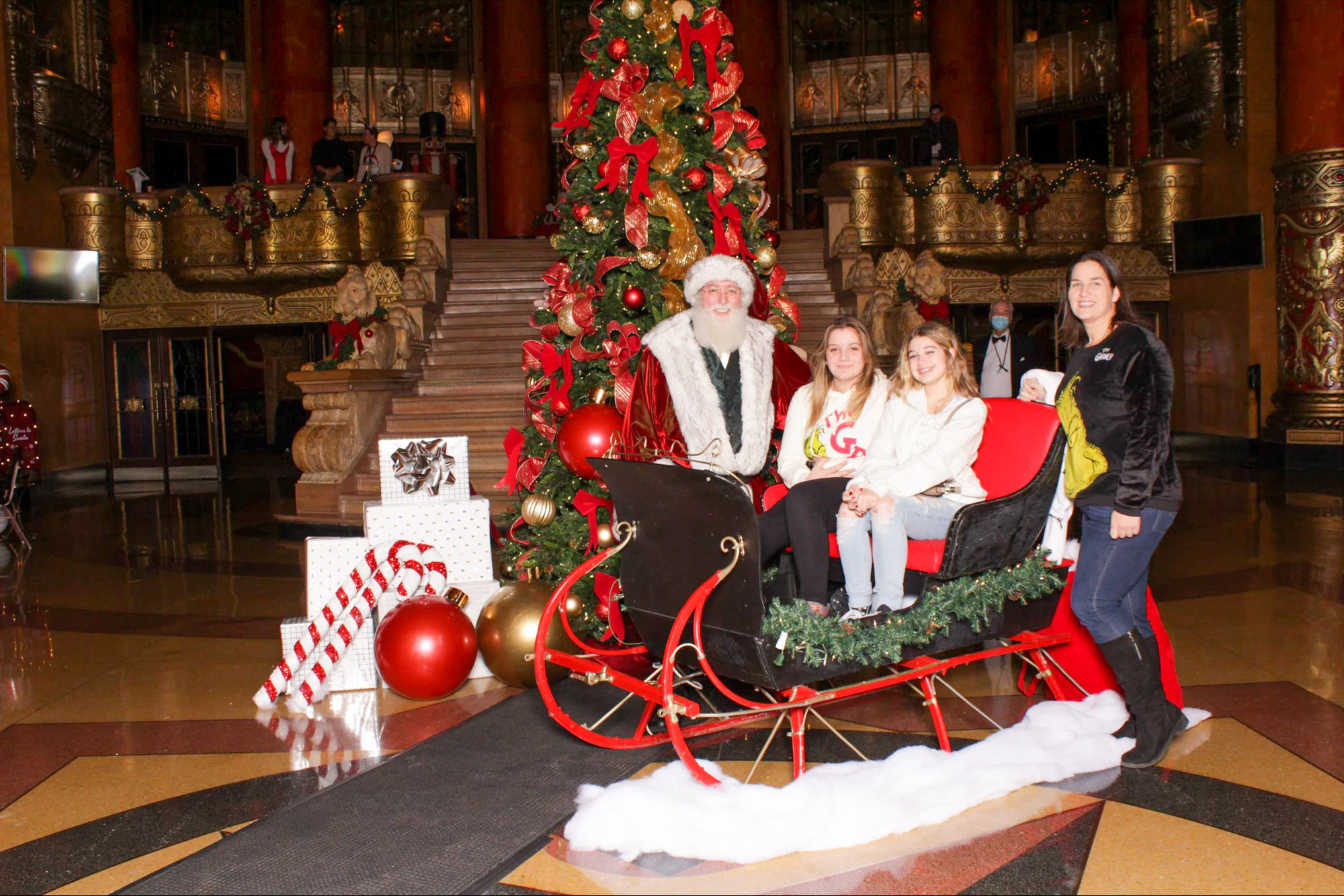 Guests in Santa’s sleigh in the Fox Theatre lobby at the 313 Presents holiday event