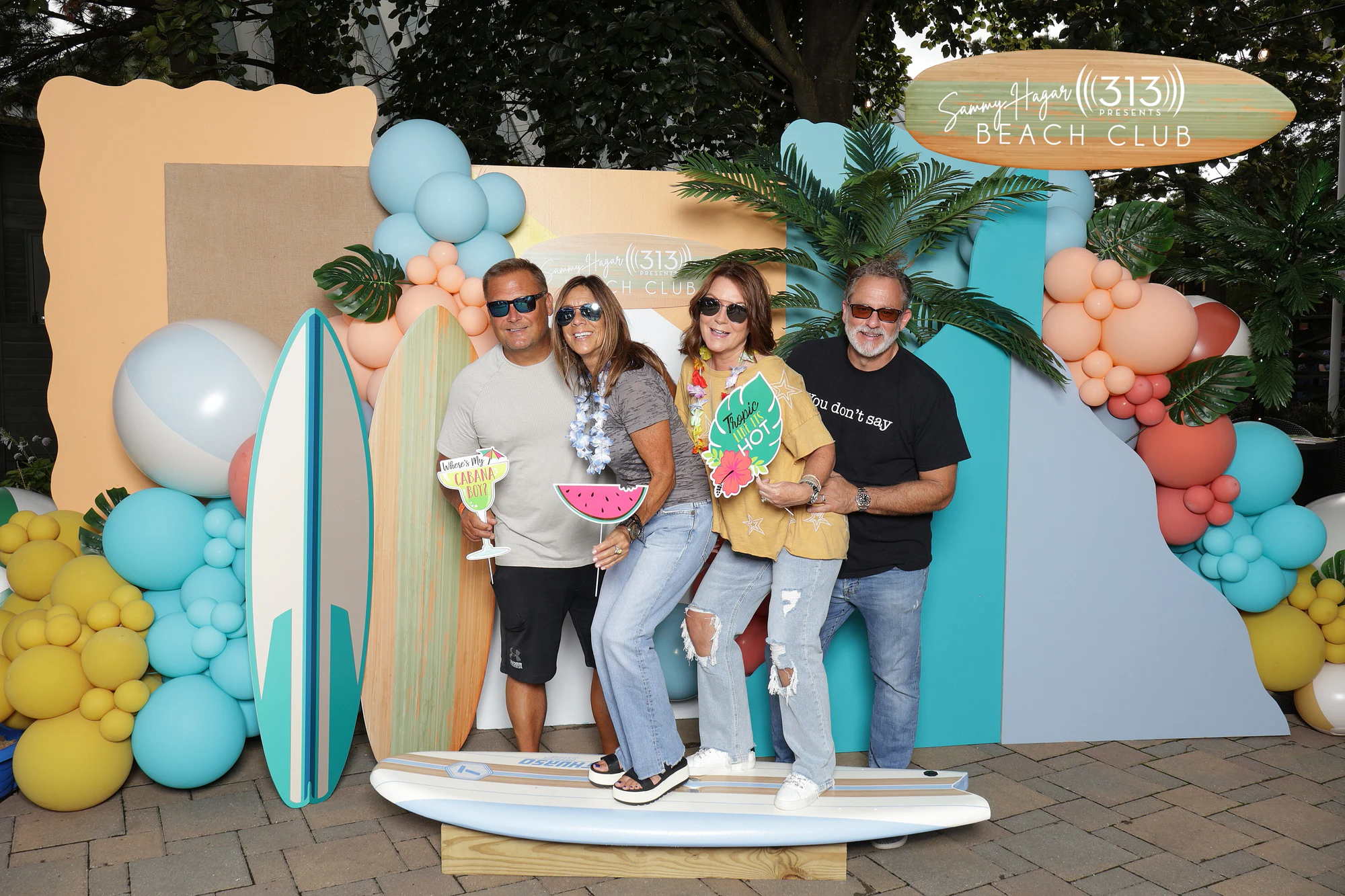 Four guests on the Beach Club set with paper watermelon and drink props at Sammy Hagar at Pine Knob with 313 Presents
