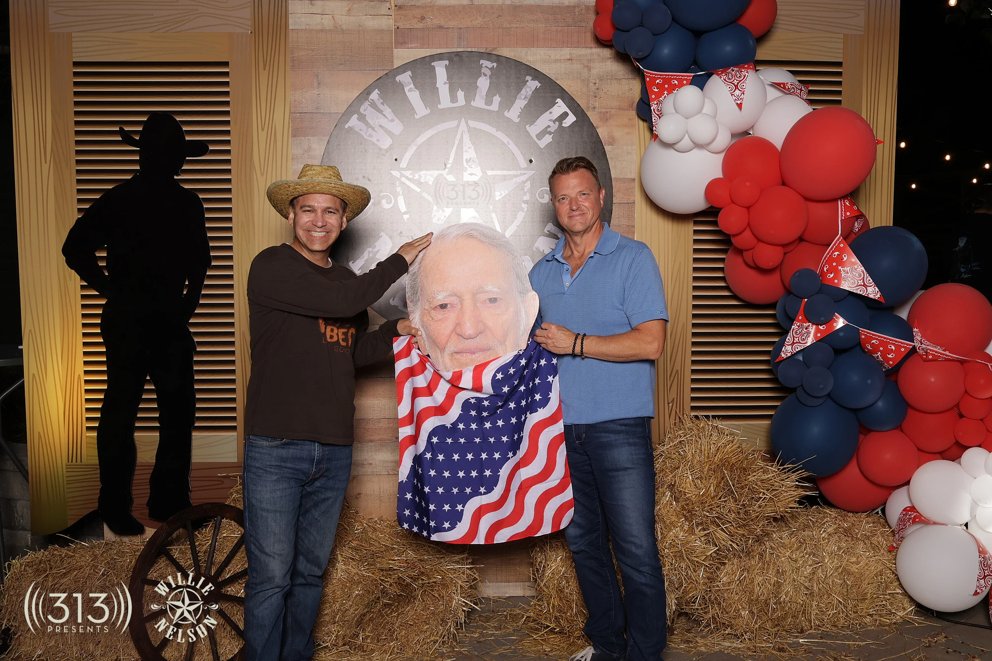 Two guests holding the Willie Nelson cutout between them at Willie Nelson VIP Party with 313 Presents