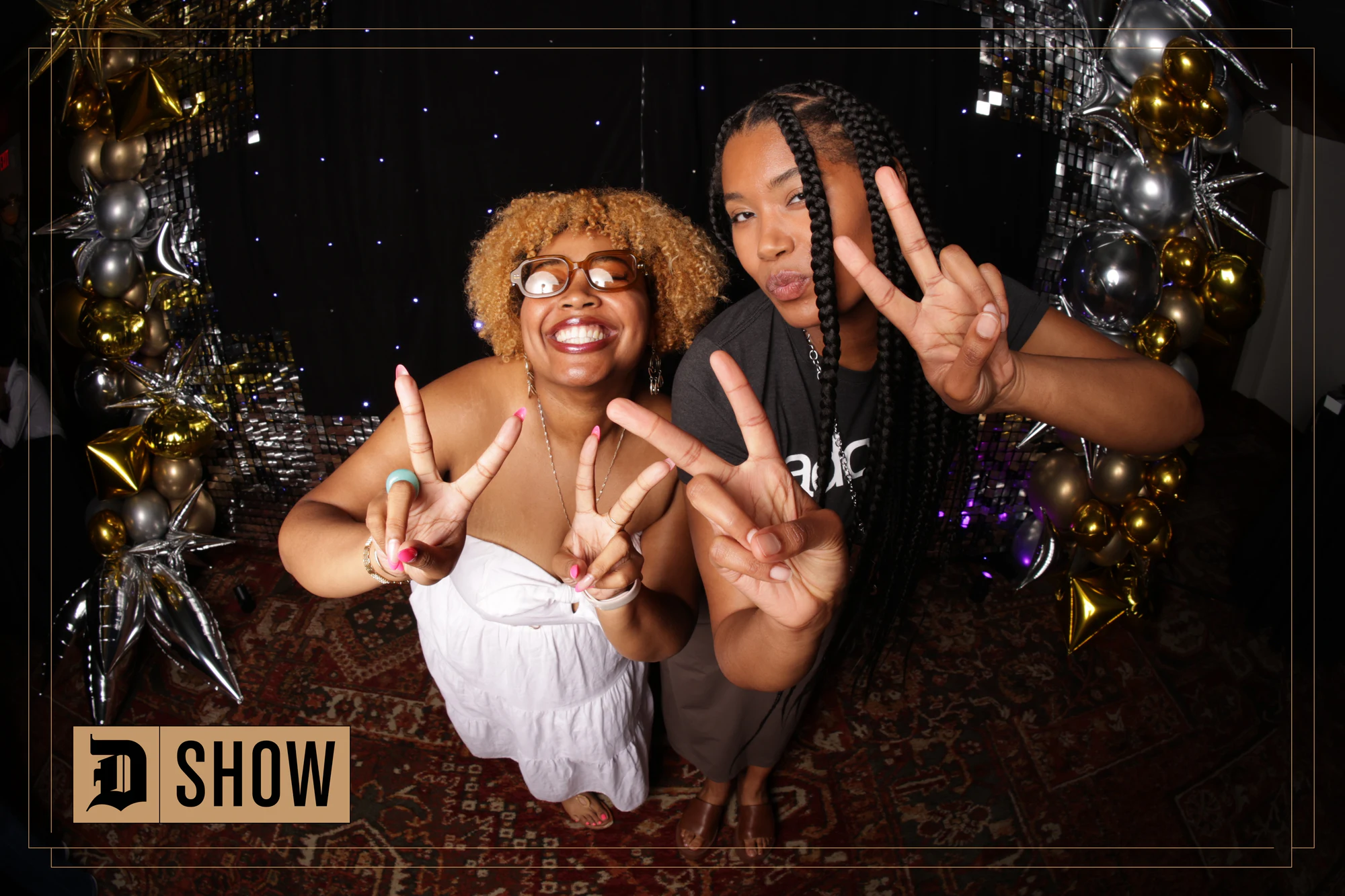 Two guests throwing peace signs up at the camera at The D Show 2024