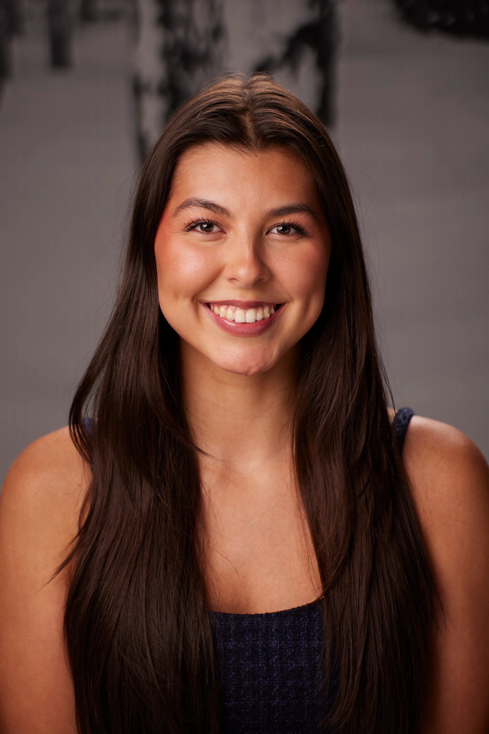 A headshot of a guest with long dark hair and a wide smile at the AMITY Coworking grand reopening
