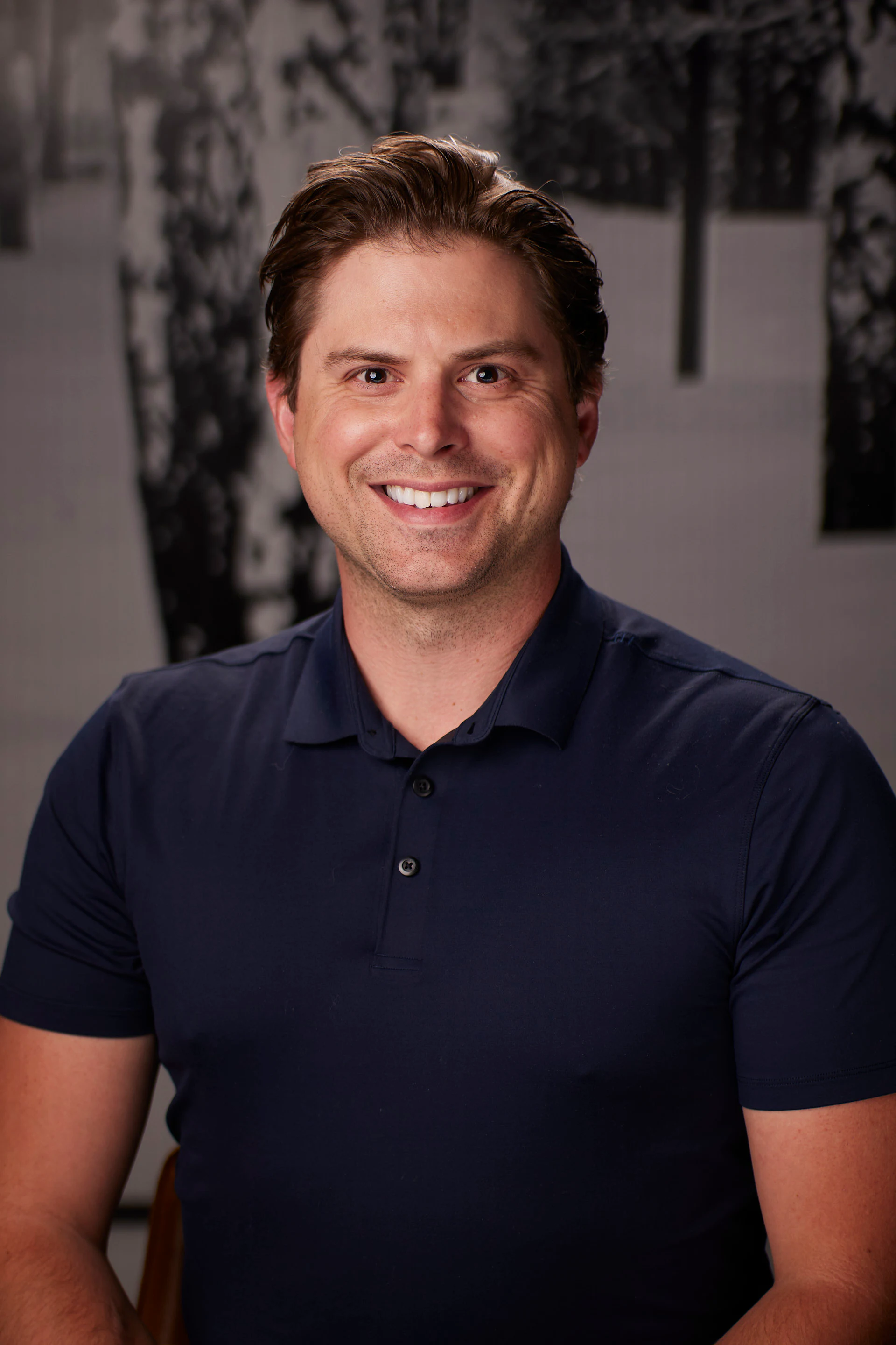 A headshot of a guest in a navy polo at the AMITY Coworking grand reopening
