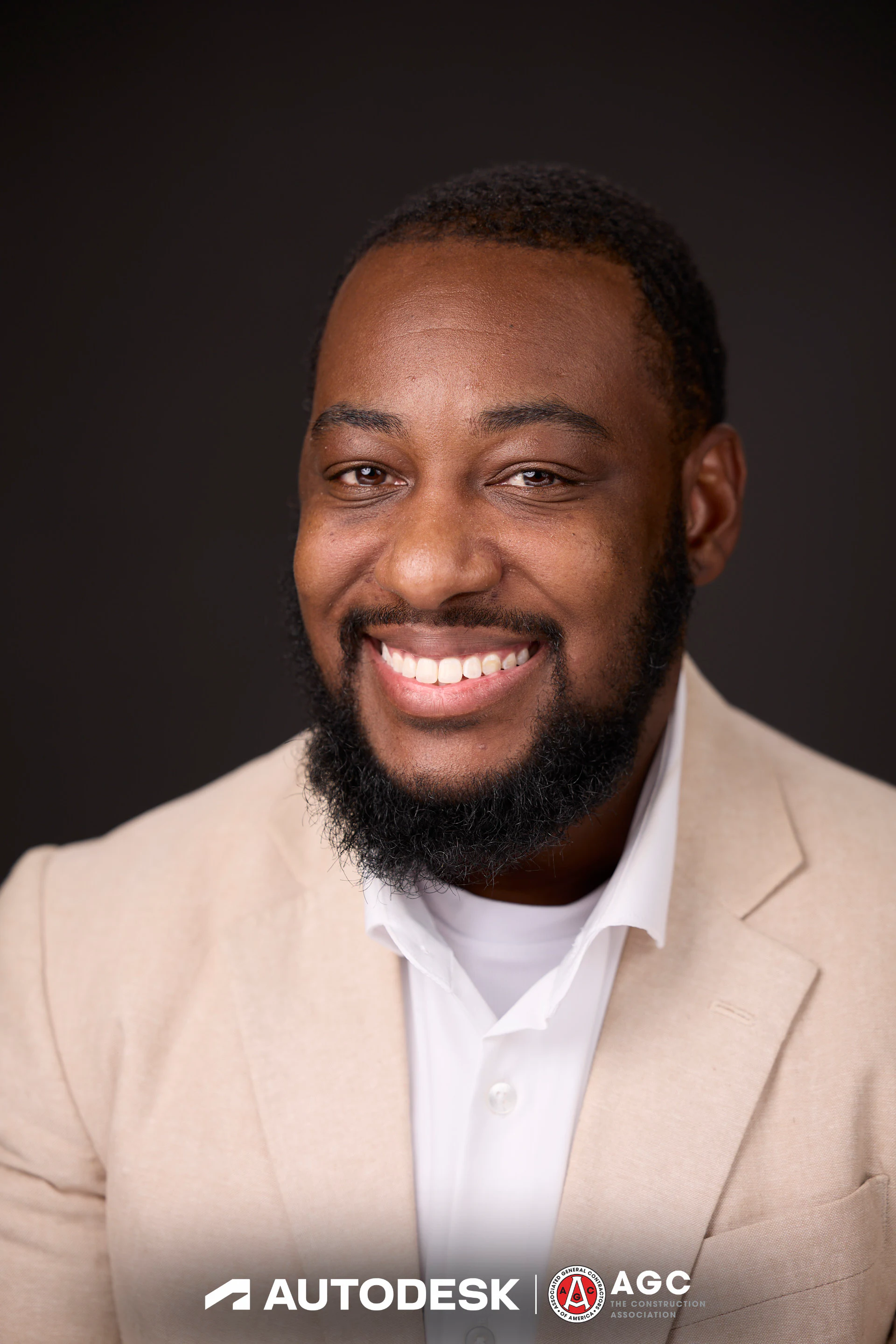 A headshot of a guest in a cream blazer with a wide smile at Autodesk at the AGC Annual Convention 2025