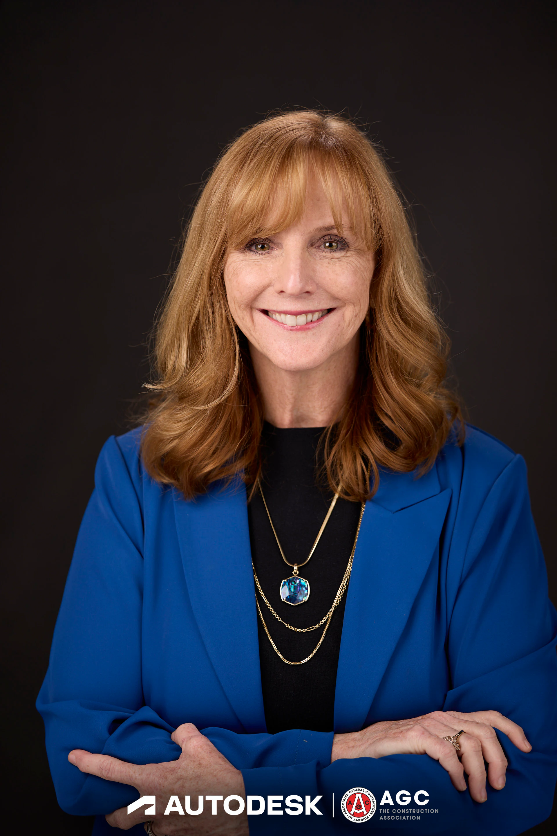 A headshot of a guest in a blue blazer with her arms folded at Autodesk at the AGC Annual Convention 2025