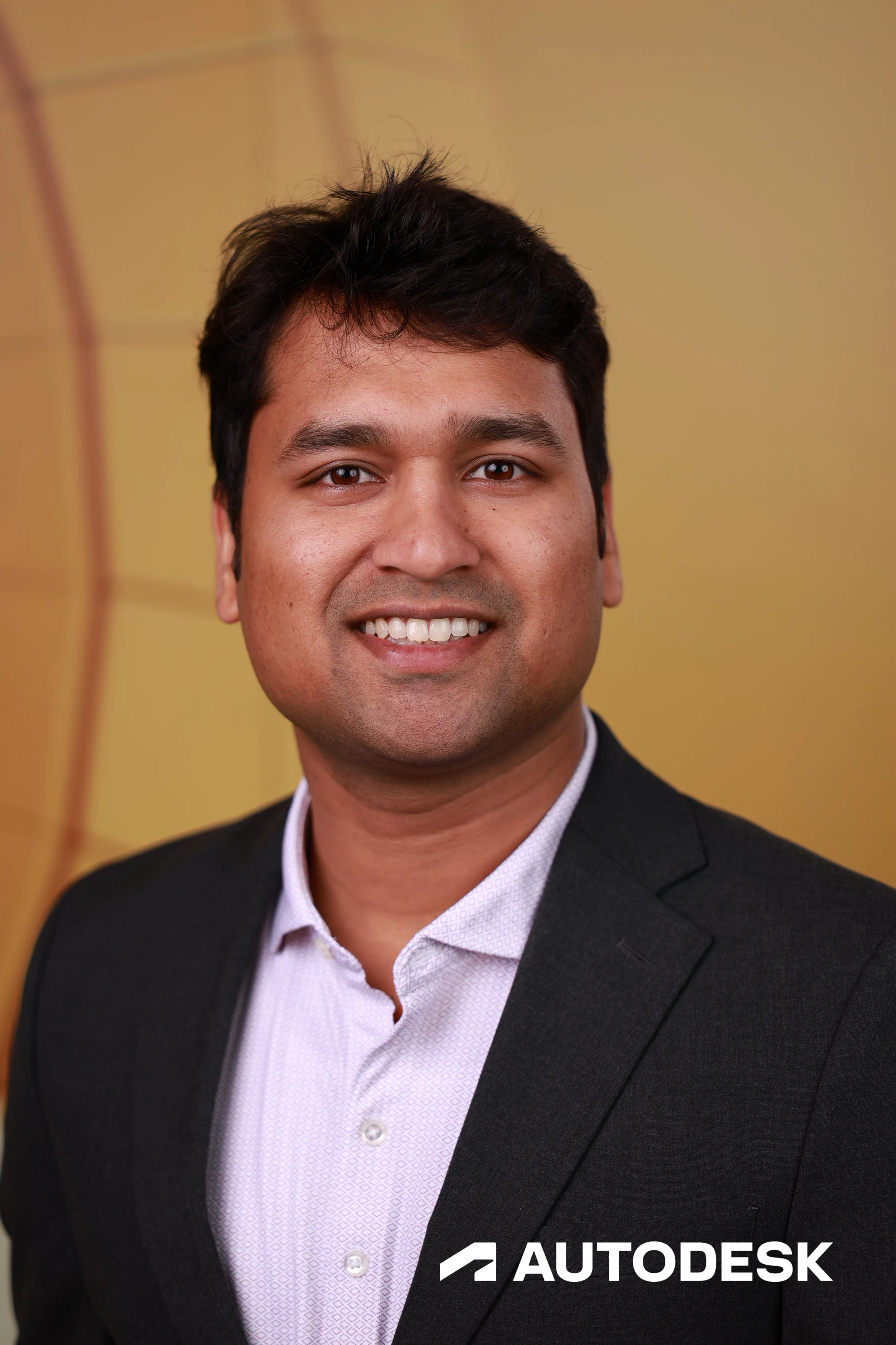 A headshot of a guest in a dark blazer over a pale shirt at Autodesk at the AGC Annual Convention 2026