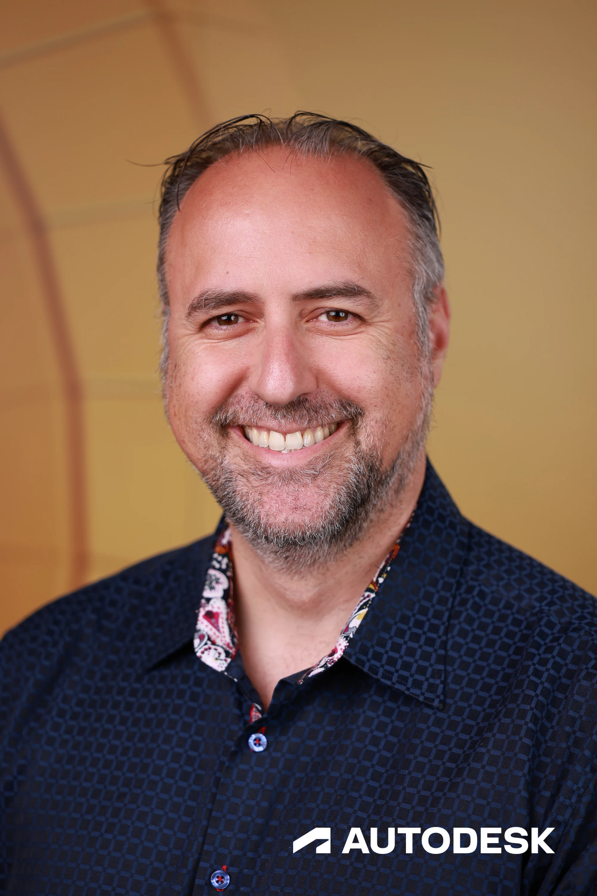 A headshot of a guest in a patterned navy shirt at Autodesk at the AGC Annual Convention 2026