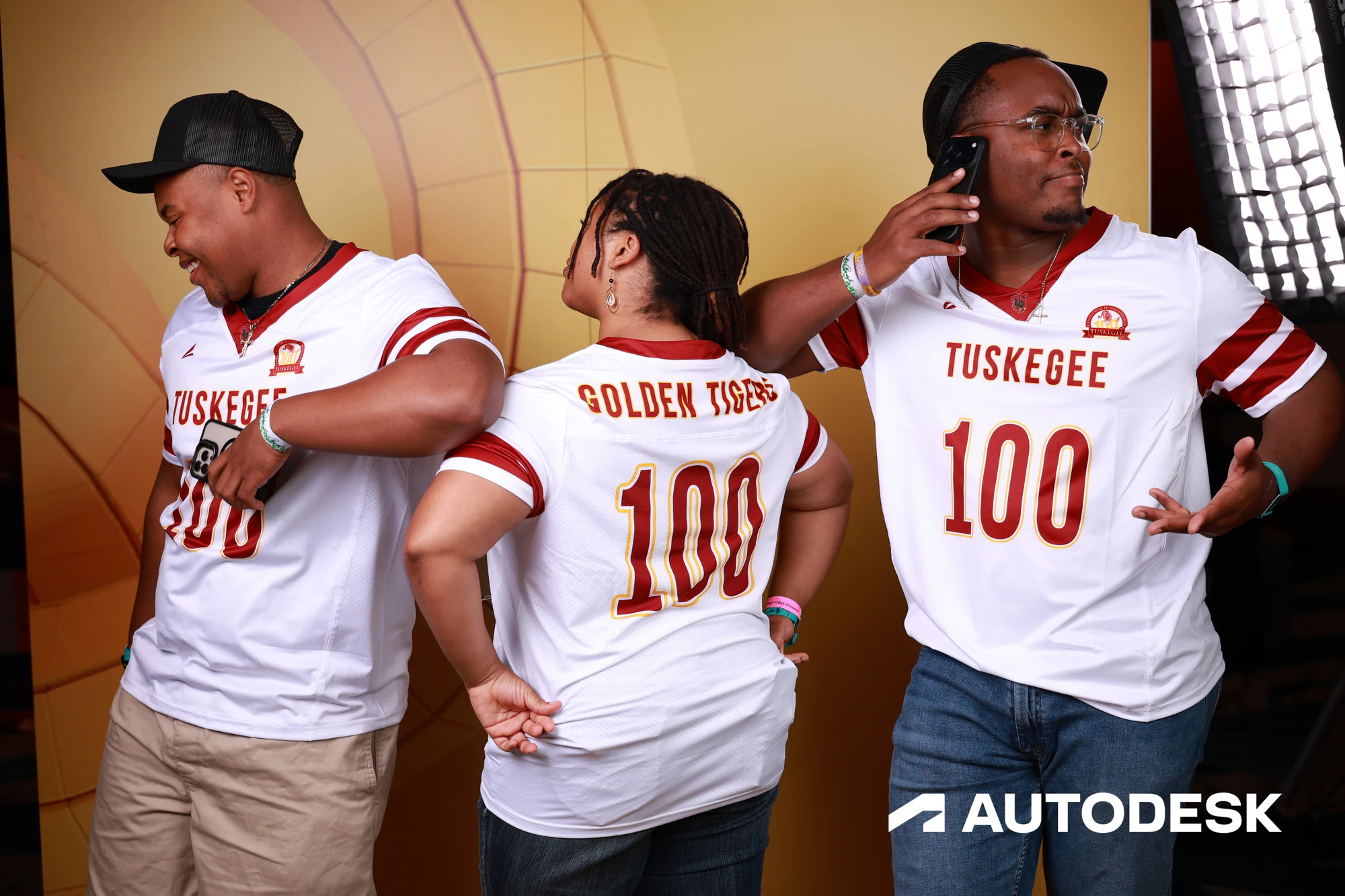 Three guests turned to show the numbers on the backs of their jerseys at Autodesk at the AGC Annual Convention 2026