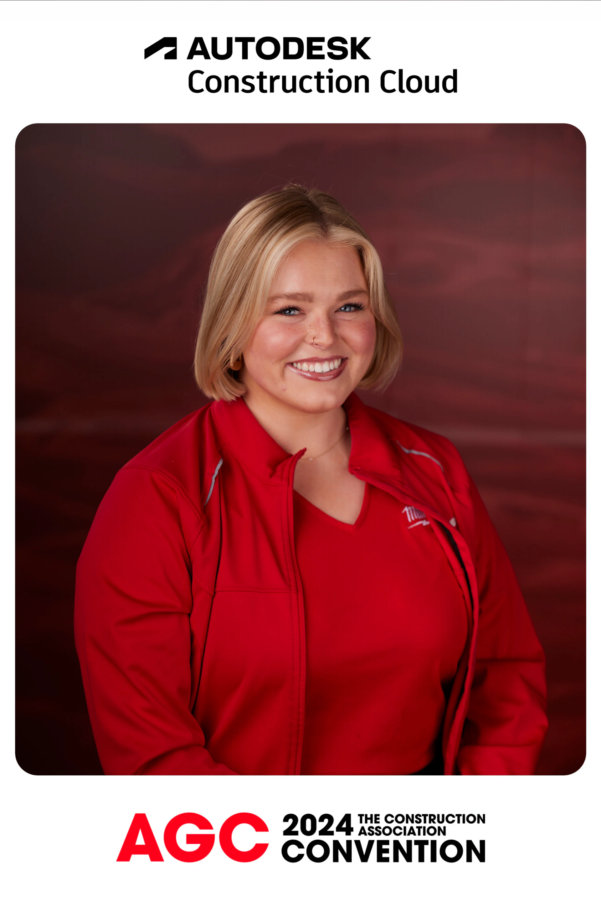 A guest with a blonde bob in a red jacket smiling in her framed headshot at Autodesk at the AGC Annual Convention