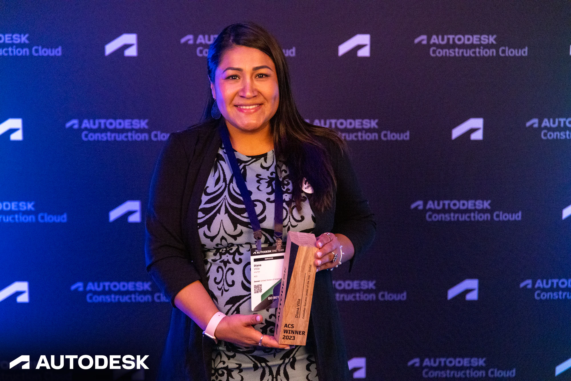 The winner smiling with her trophy at the Autodesk OTC Awards 2023