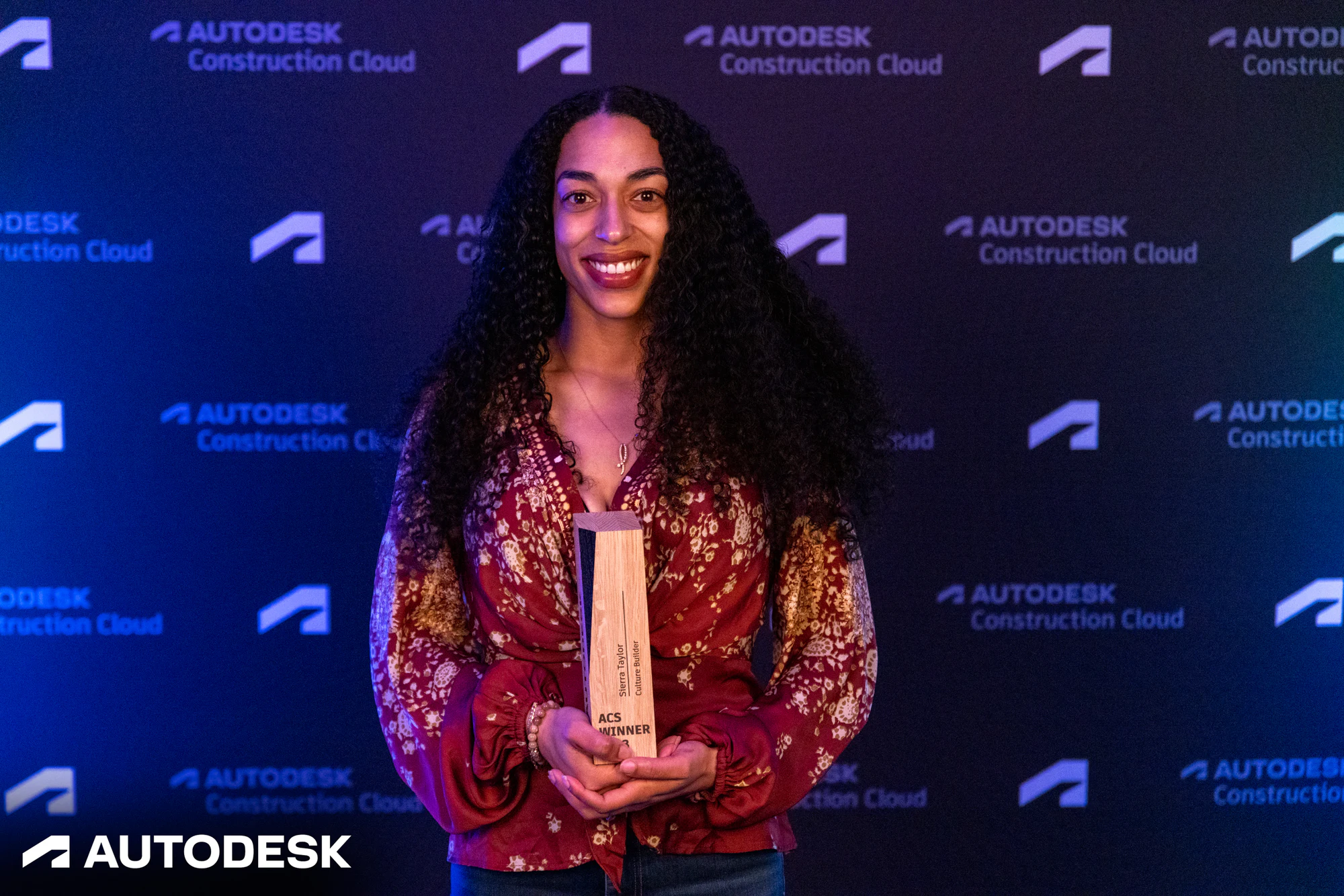 The winner with her trophy, a closer frame at the Autodesk OTC Awards 2023