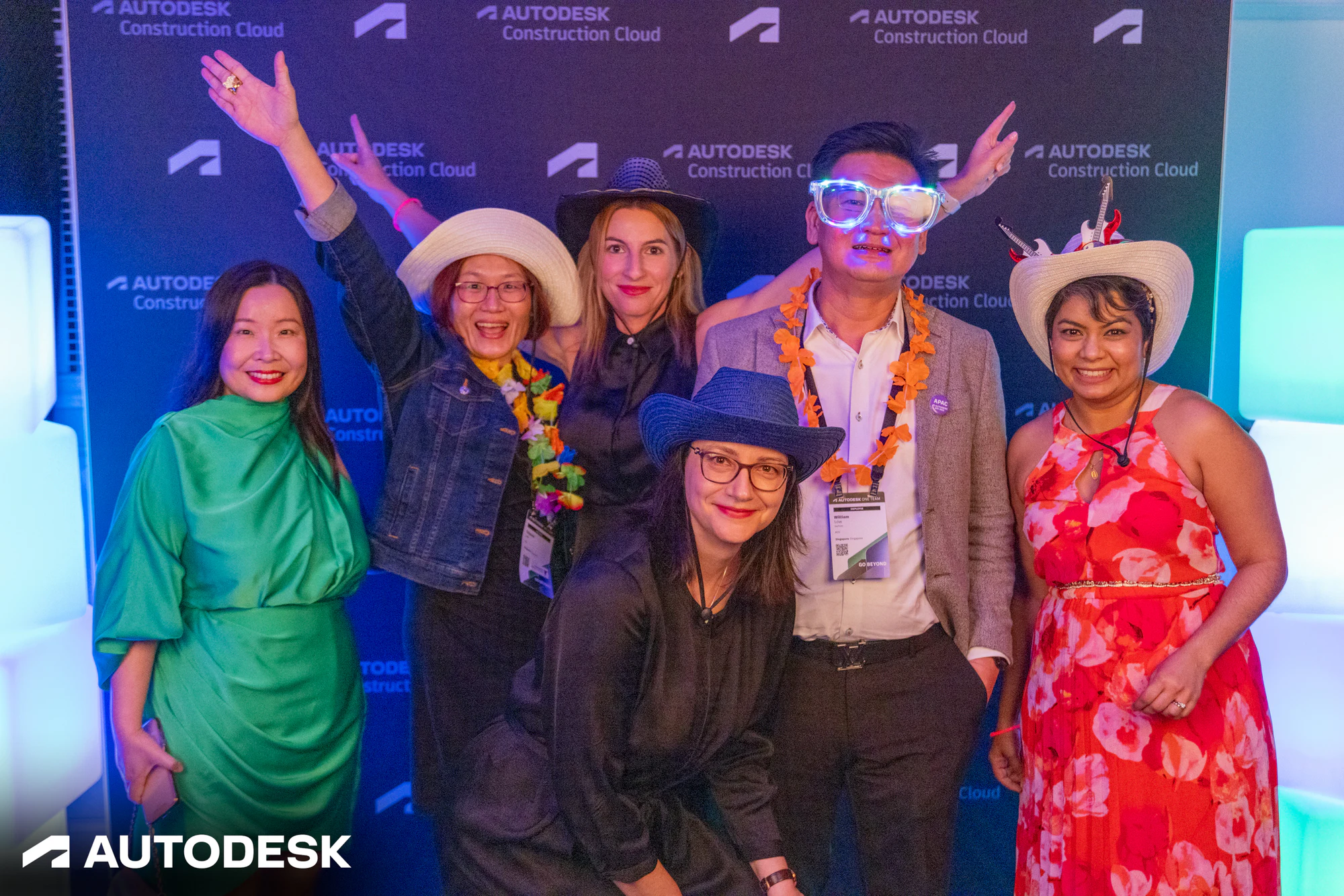 The six at the backdrop with their arms up at the Autodesk OTC Awards 2023