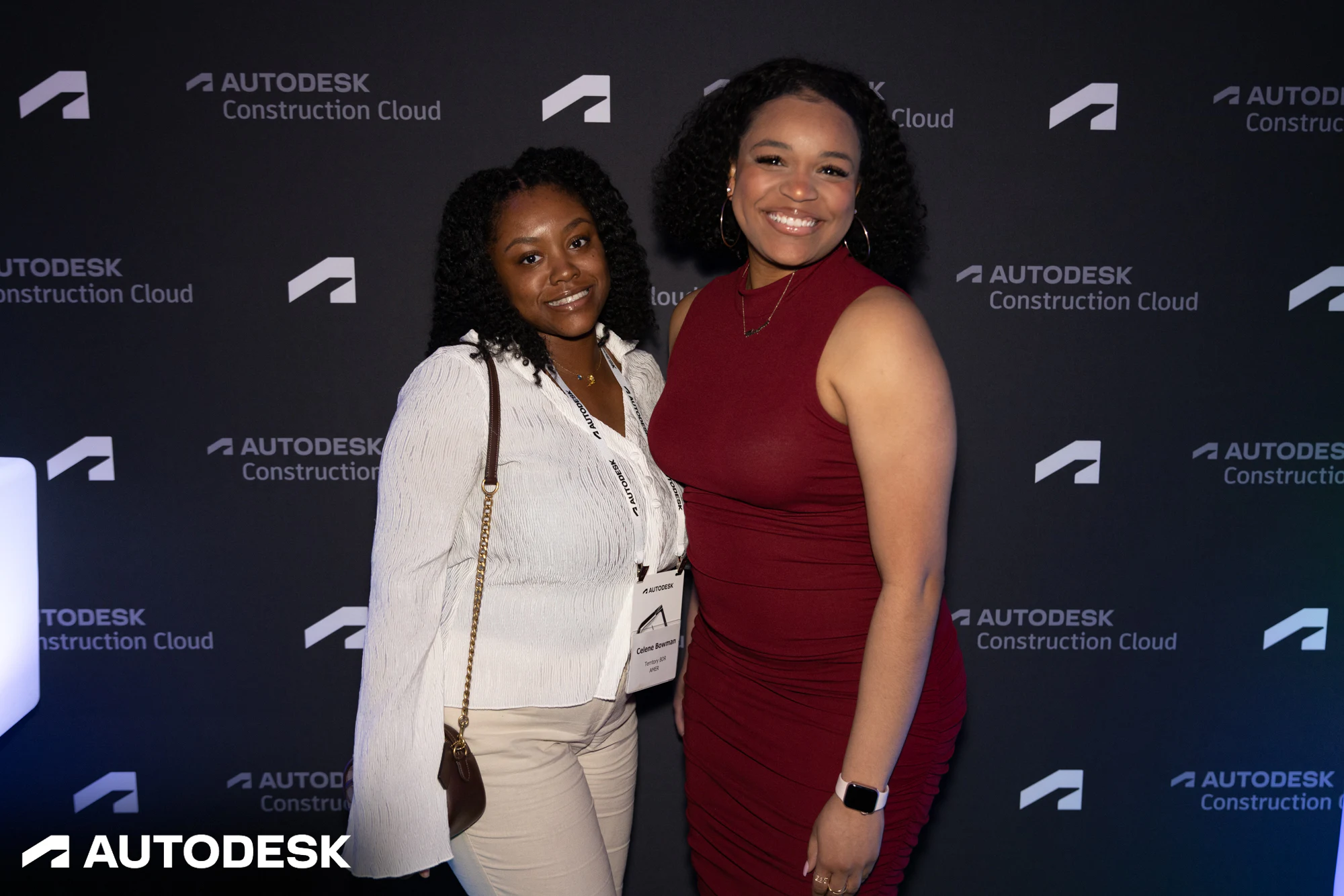 Two guests in white and red at the step and repeat at Autodesk Awards Atlanta 2023