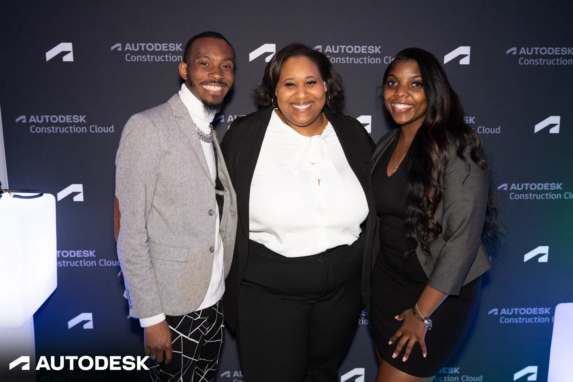 Three guests together at the Autodesk Construction Cloud step and repeat at Autodesk Awards Atlanta 2023