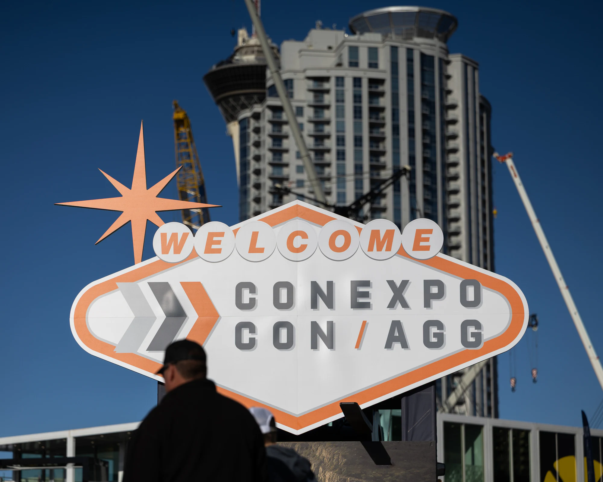 The Welcome CONEXPO-CON/AGG sign with a tower and cranes behind it at Autodesk at CONEXPO-CON/AGG 2026