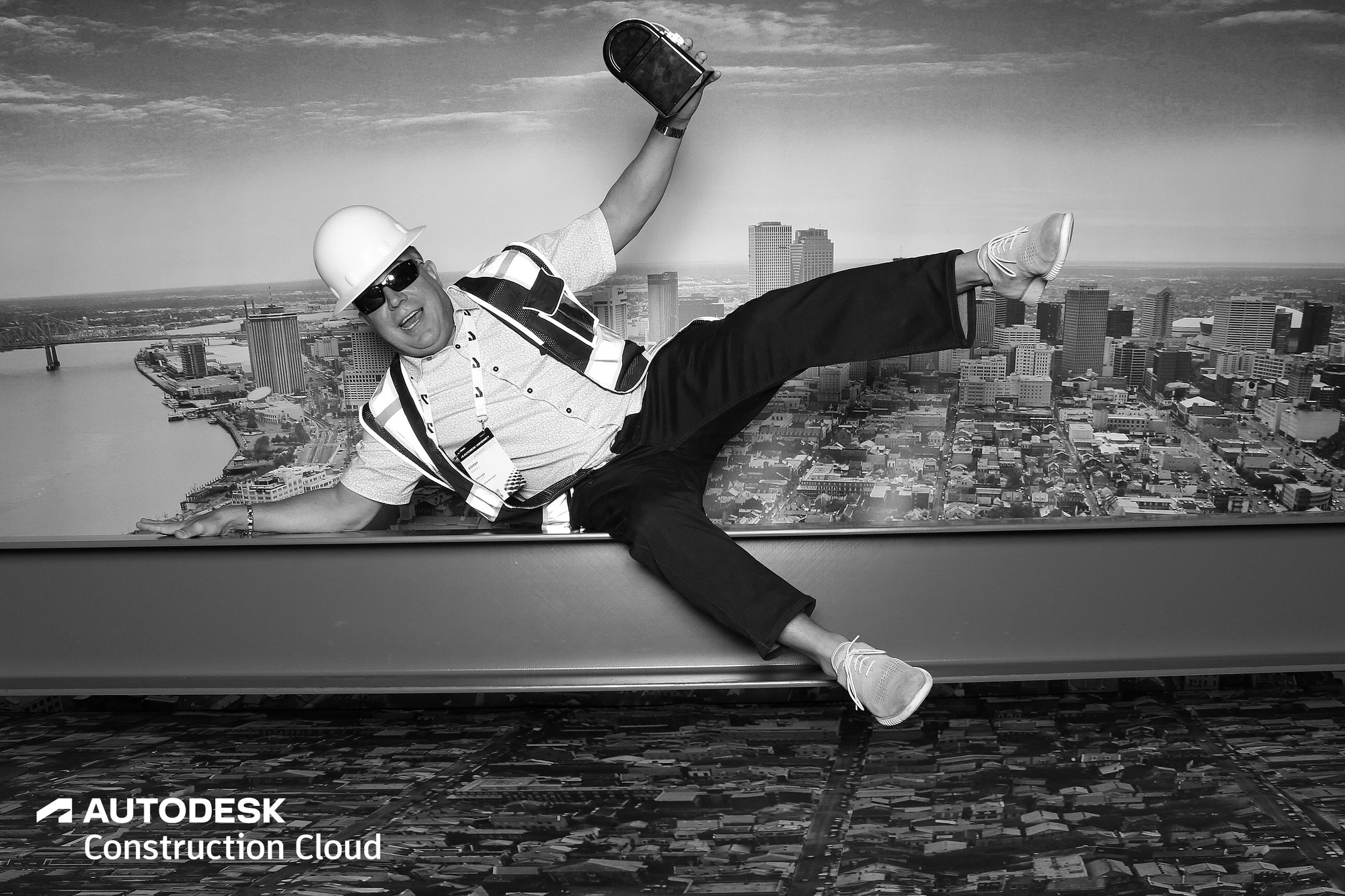 Guest in a hard hat mid flying kick along the beam at Autodesk University 2022