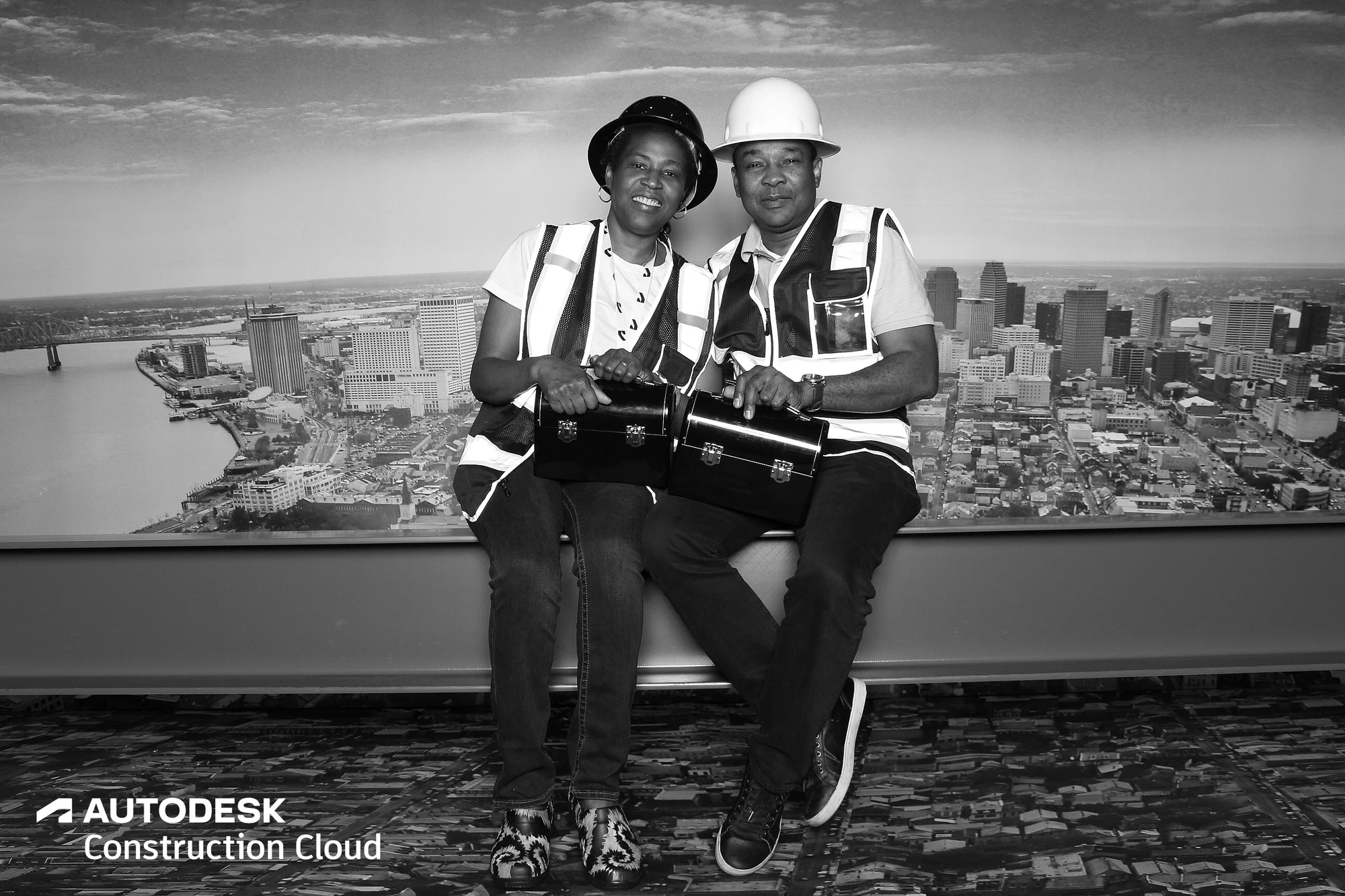 Two in vests holding lunch pails, the classic ironworker pose at Autodesk University 2022