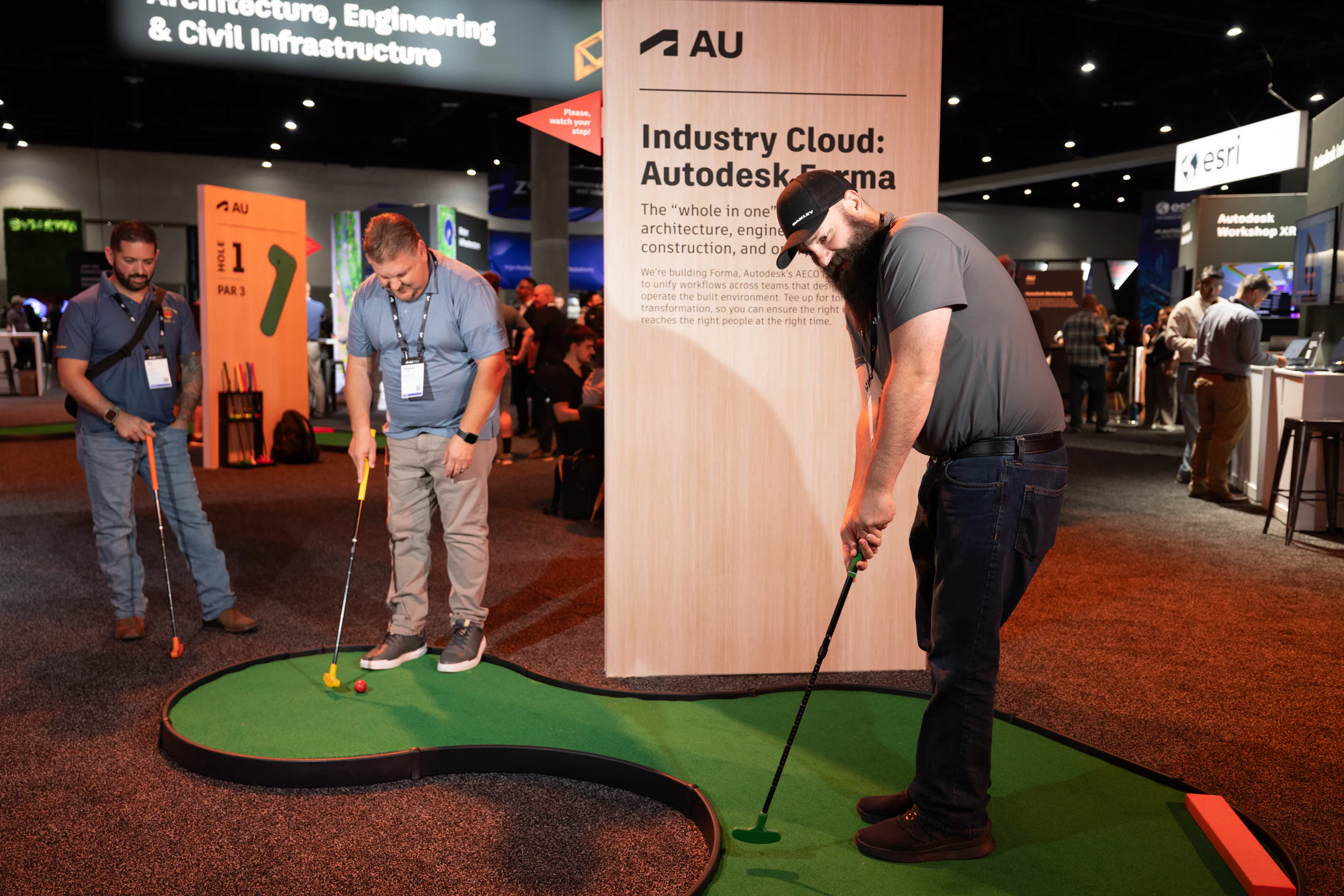Her group taking their turns on the same hole at Autodesk University 2024
