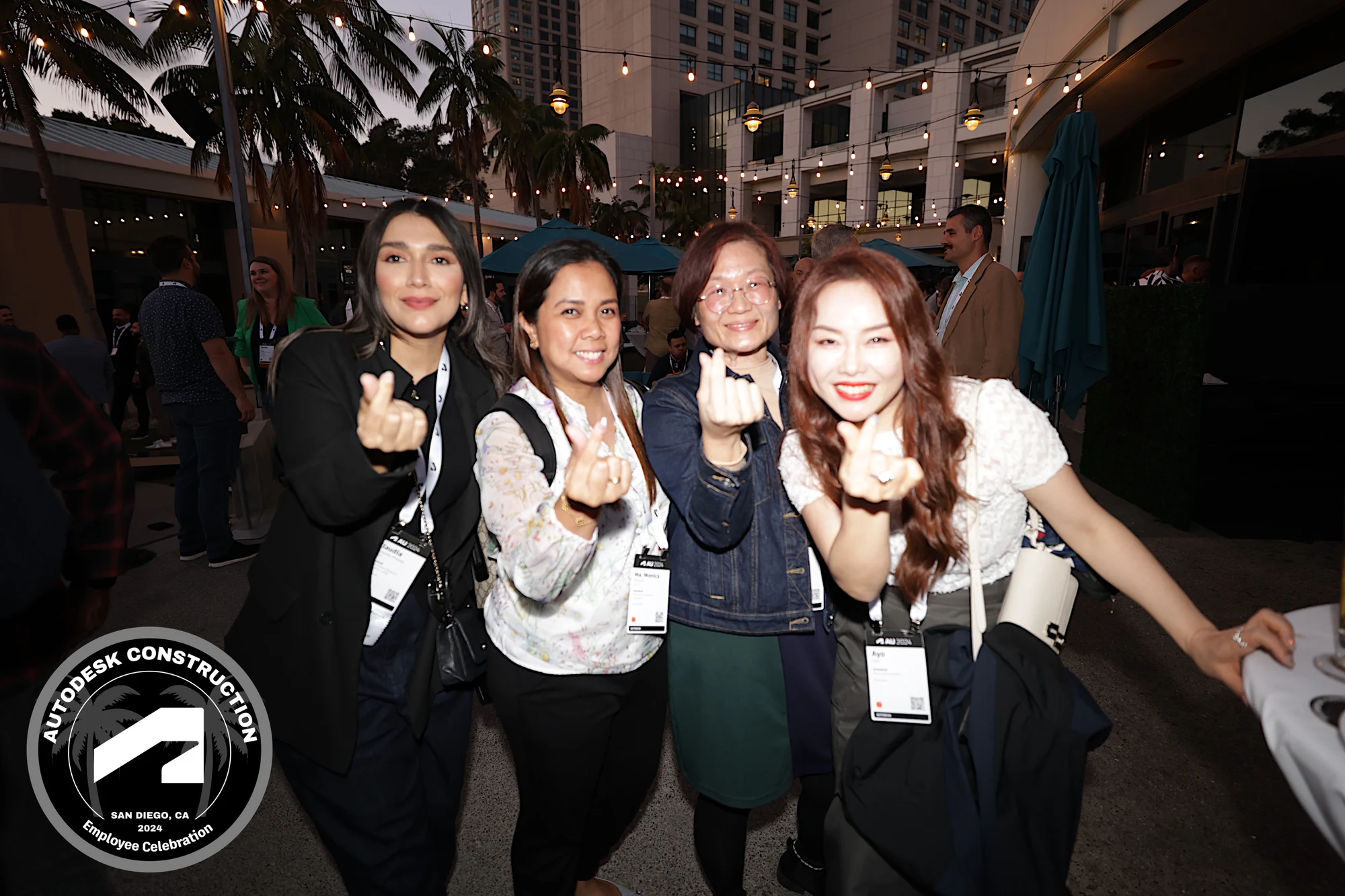 The four coworkers making finger hearts on the terrace at Autodesk University 2024
