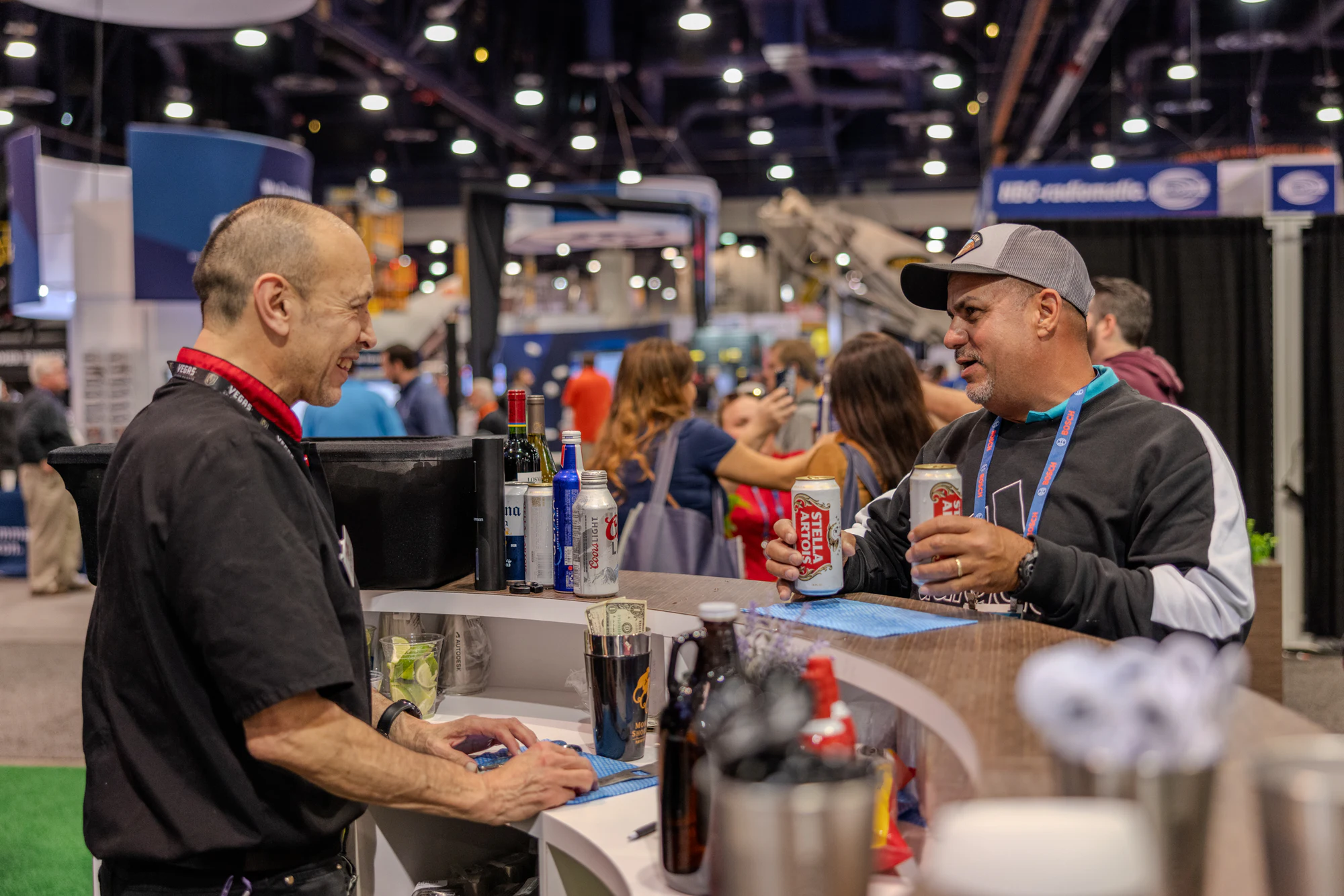 The two laughing at the bar counter at Autodesk at World of Concrete 2024
