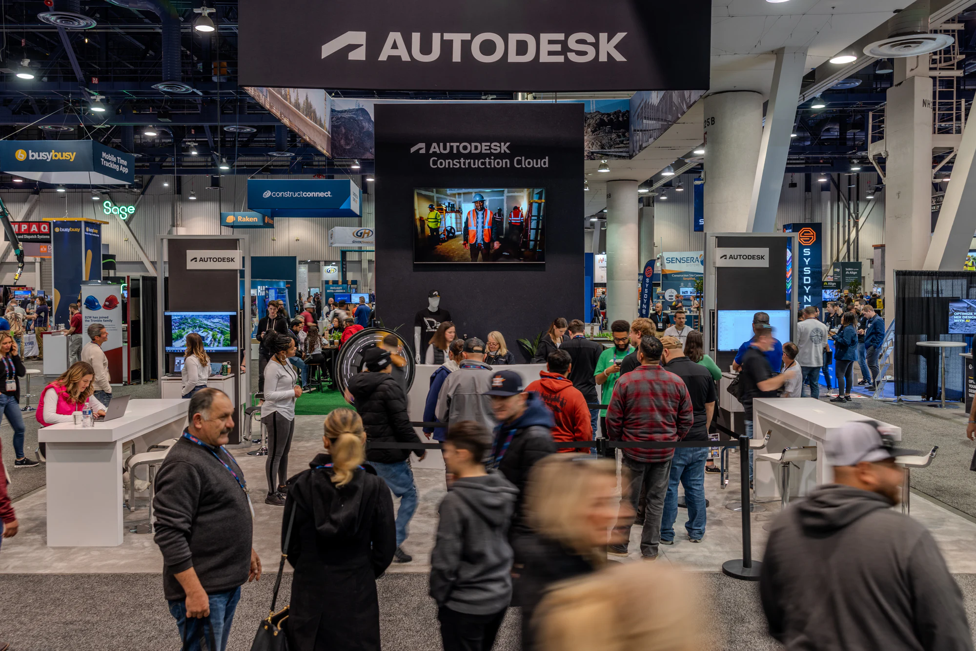 Visitors filling the Autodesk booth under its hanging sign at Autodesk at World of Concrete 2024