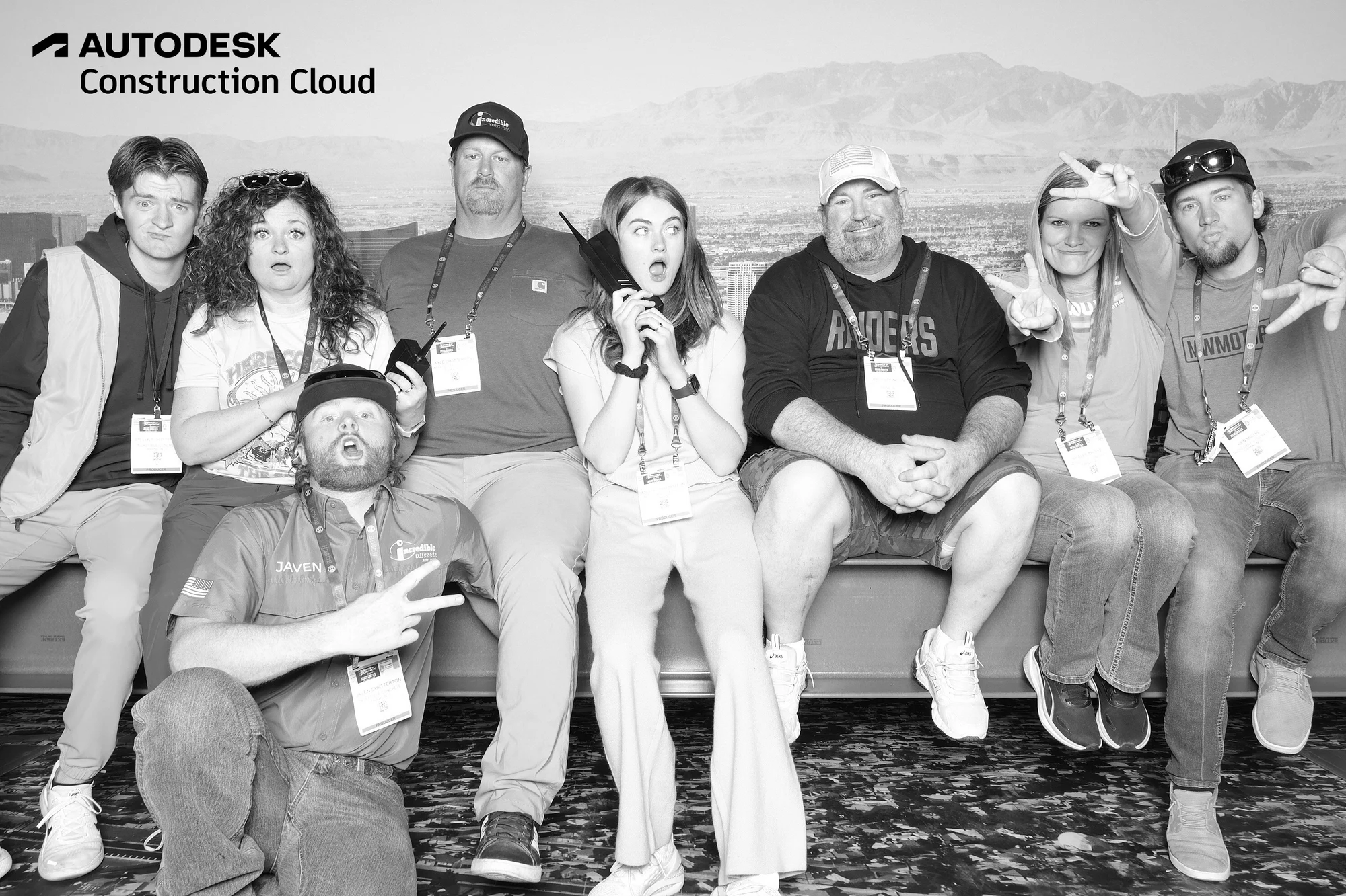 The group pulling faces on the beam, one talking into a radio at Autodesk at World of Concrete 2025