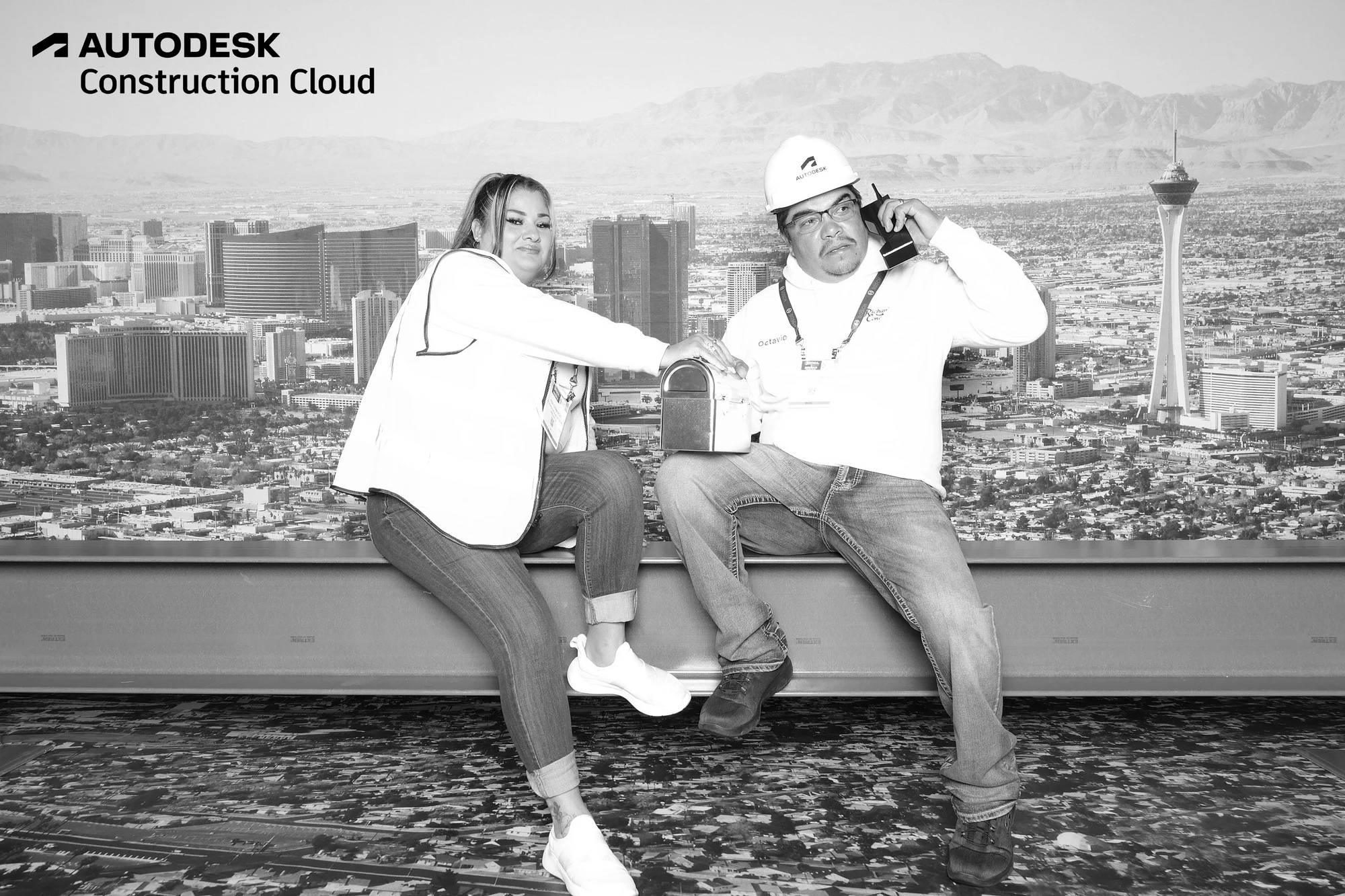 The two passing a lunchbox along the beam at Autodesk at World of Concrete 2025