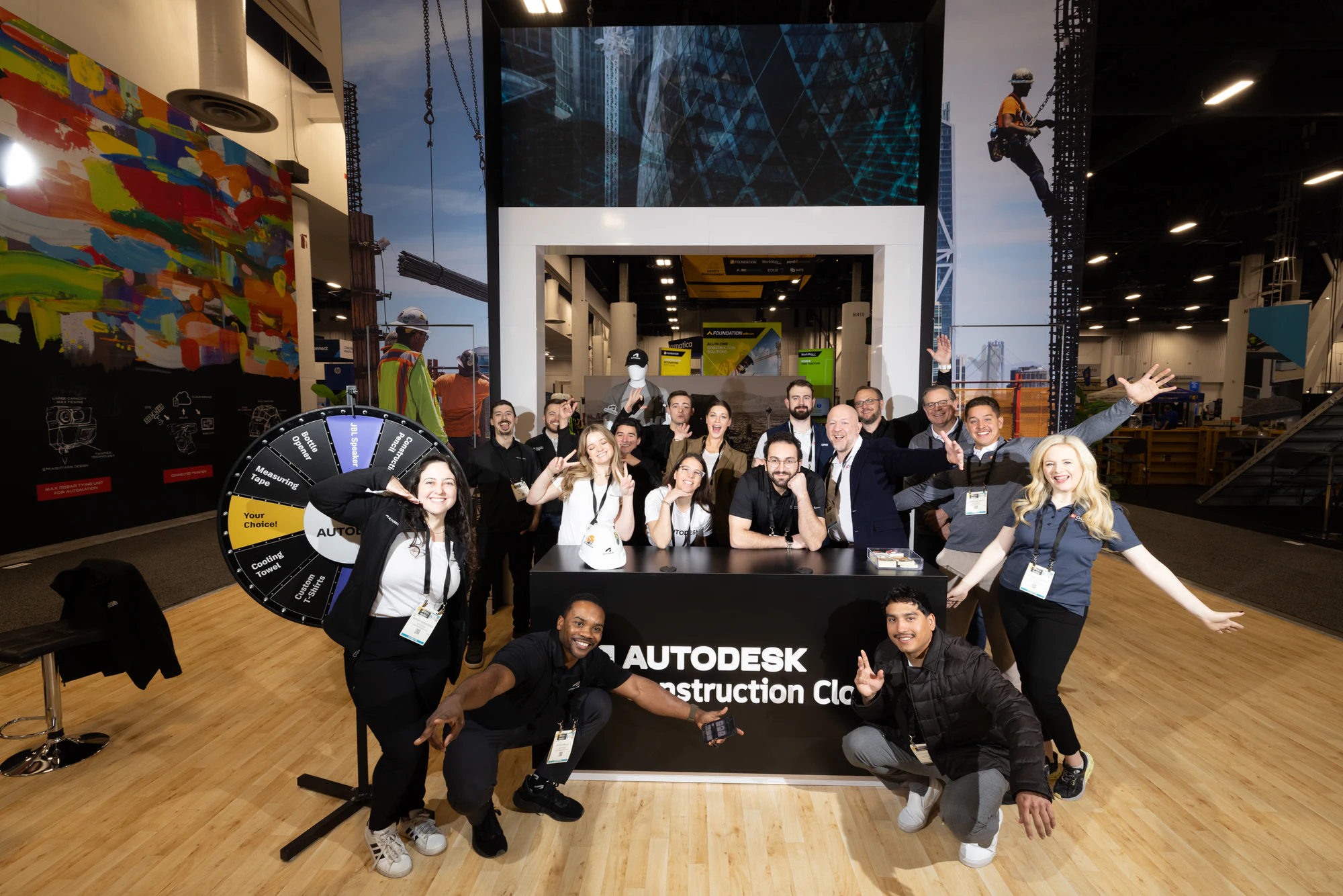 The booth team cheering with their arms out at Autodesk at World of Concrete 2025