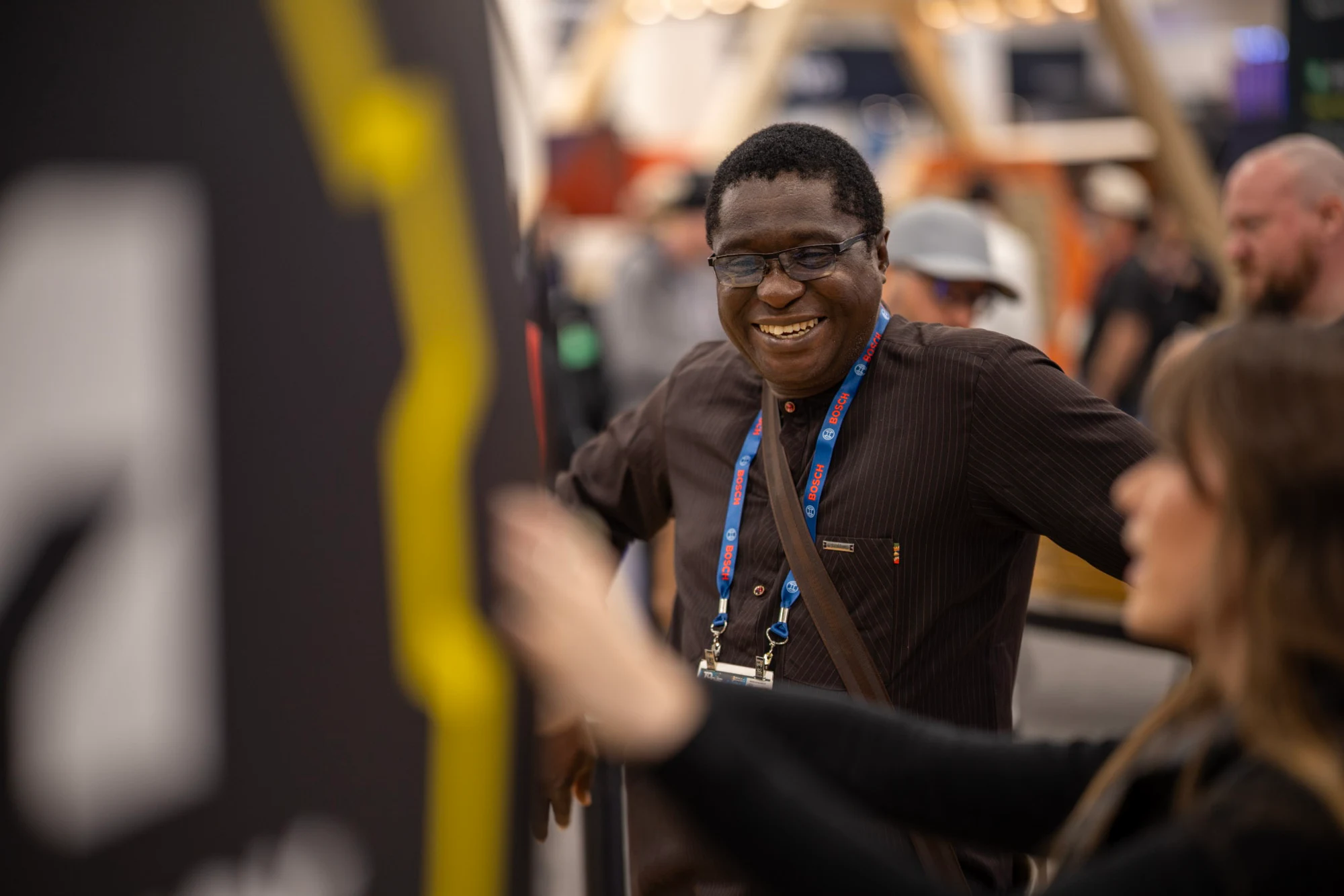 The visitor laughing with an Autodesk team member at the spinner at Autodesk at World of Concrete 2026