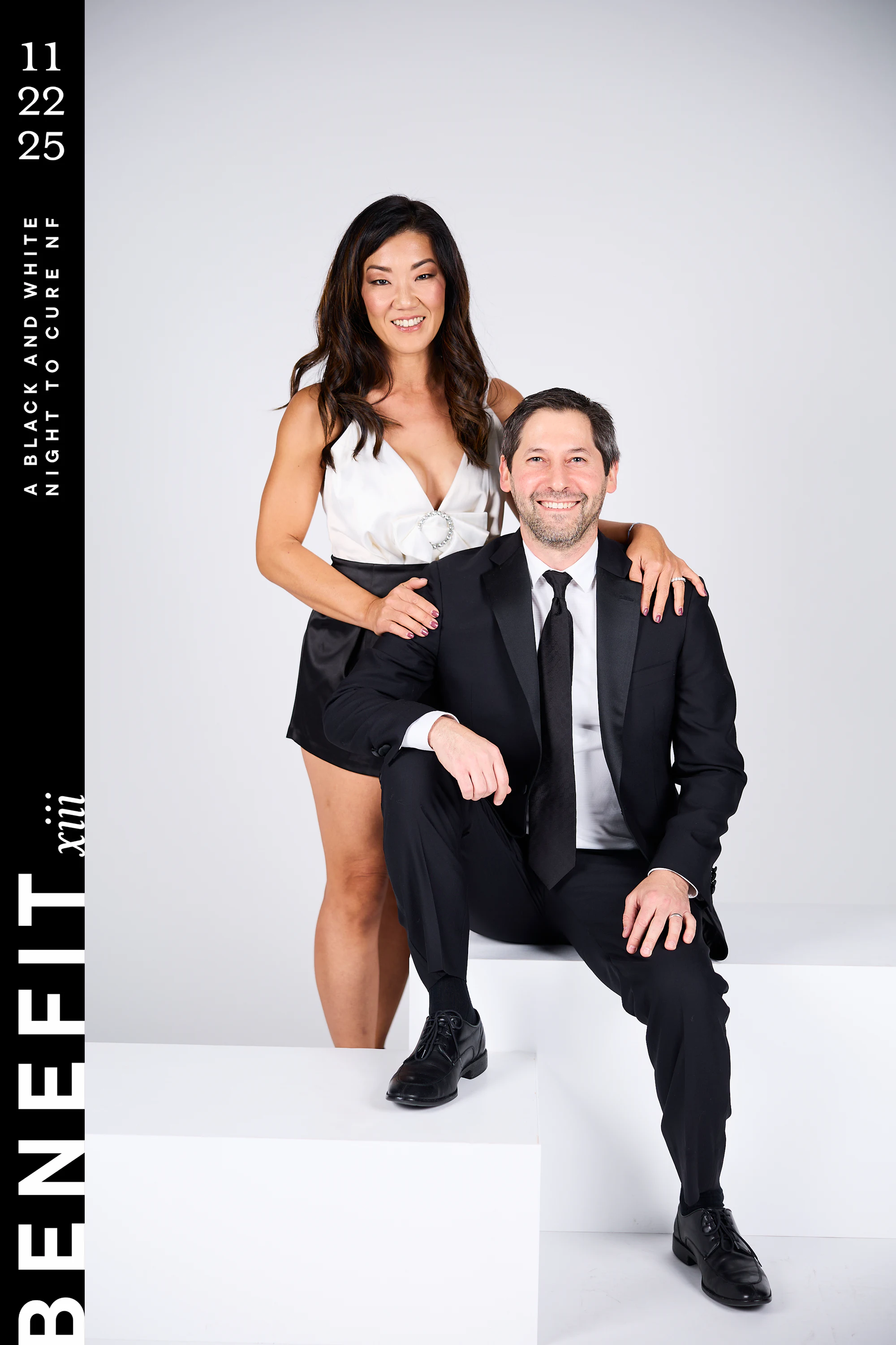 The same couple, her hand on his shoulder, both smiling at beNeFit XIII