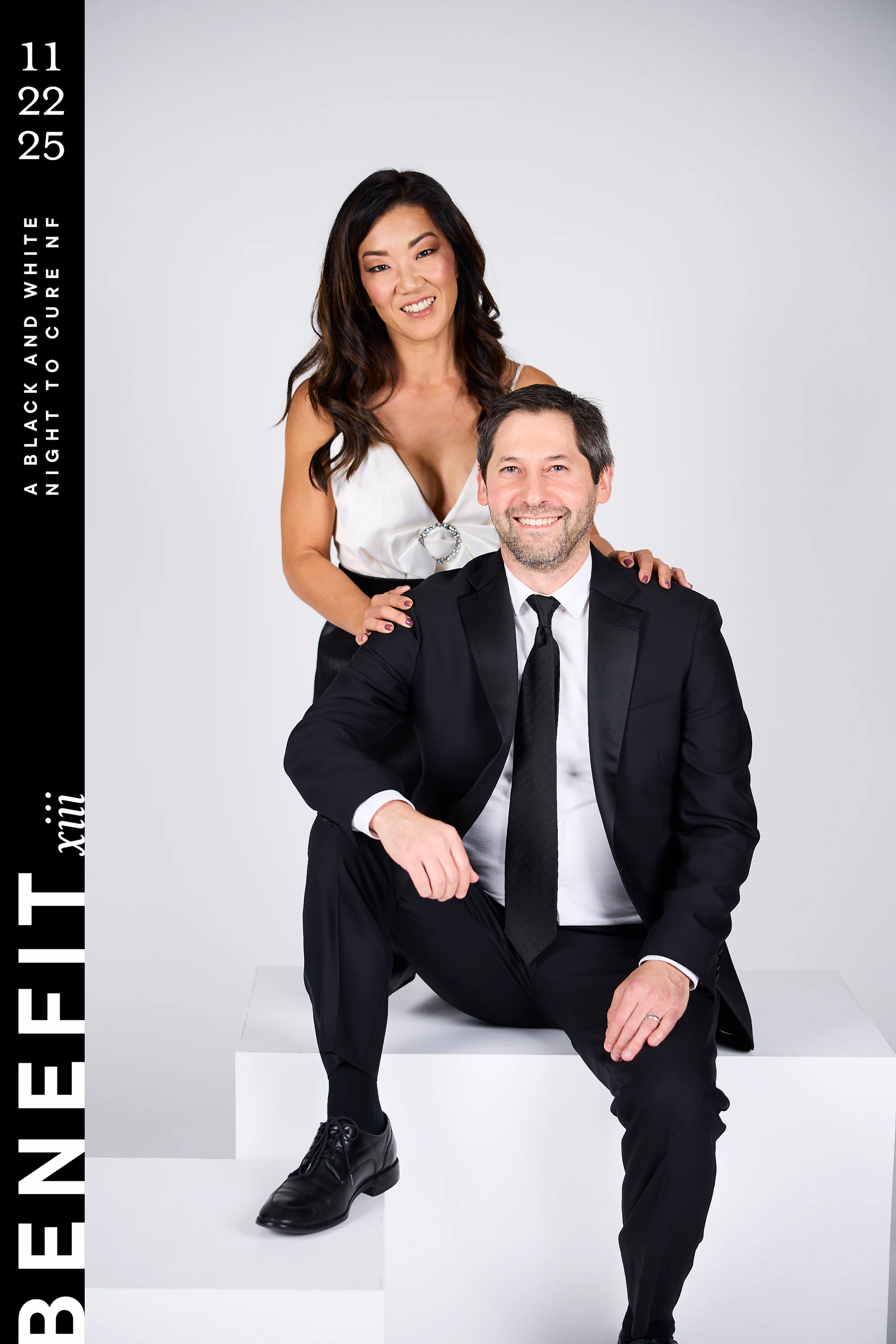The same couple, her standing behind with a hand on his shoulder at beNeFit XIII
