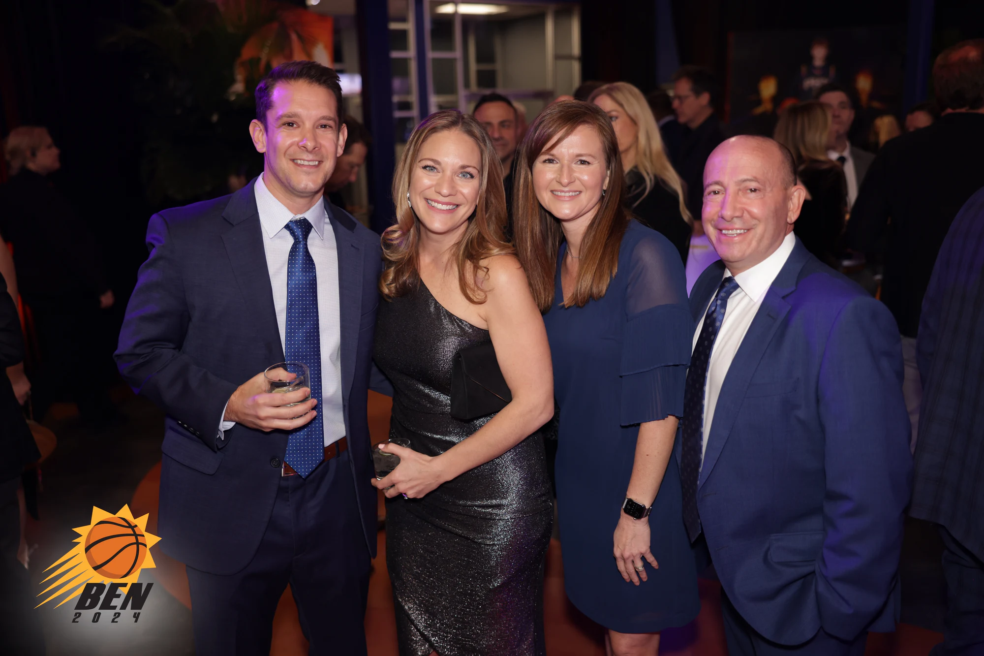 Four guests in suits and dresses, two of them holding drinks at Ben’s Bar Mitzvah