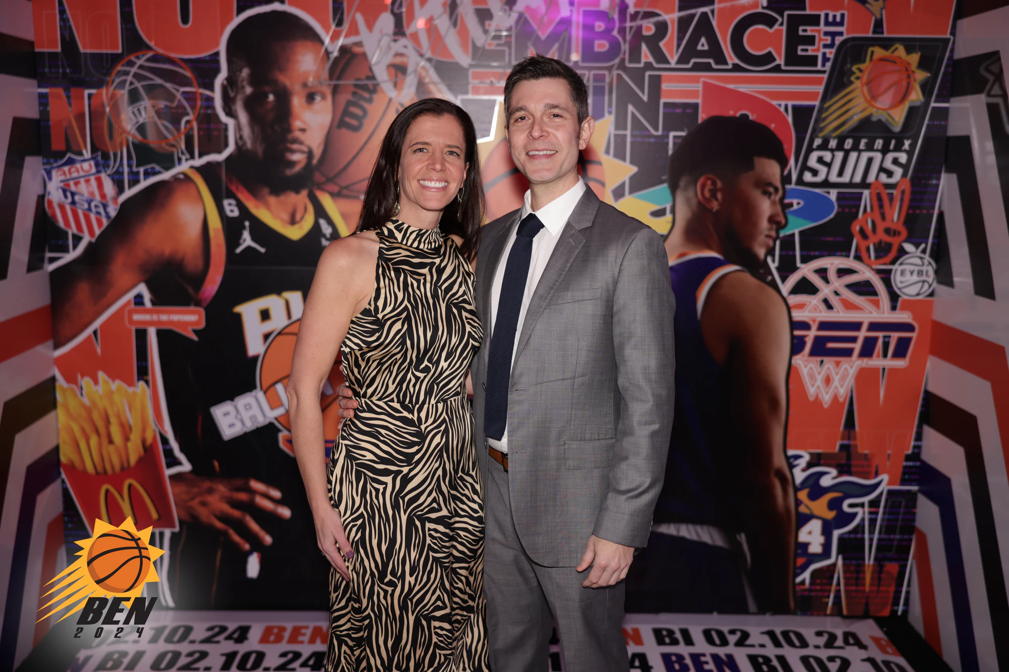 A couple in front of the basketball mural at a bar mitzvah in Pontiac