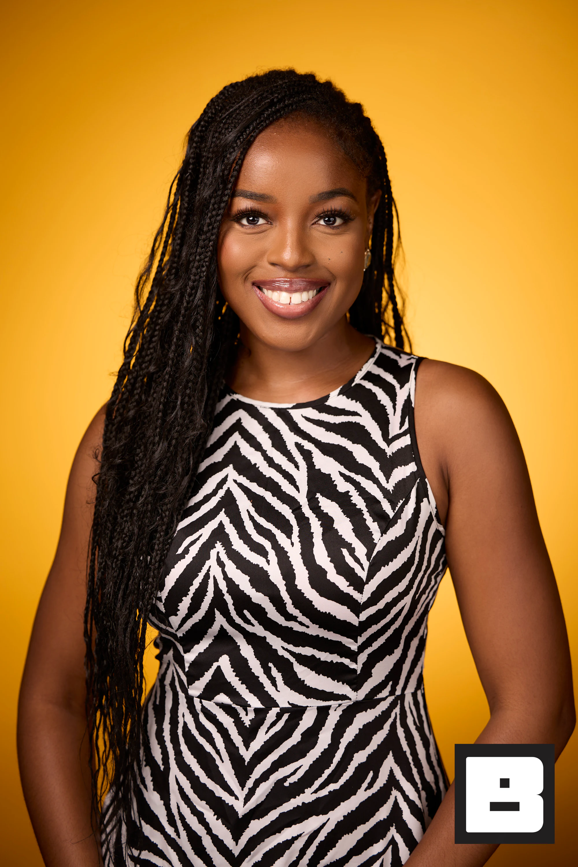 A headshot of a guest with long braids in a zebra-print dress at Black Tech Week 2025