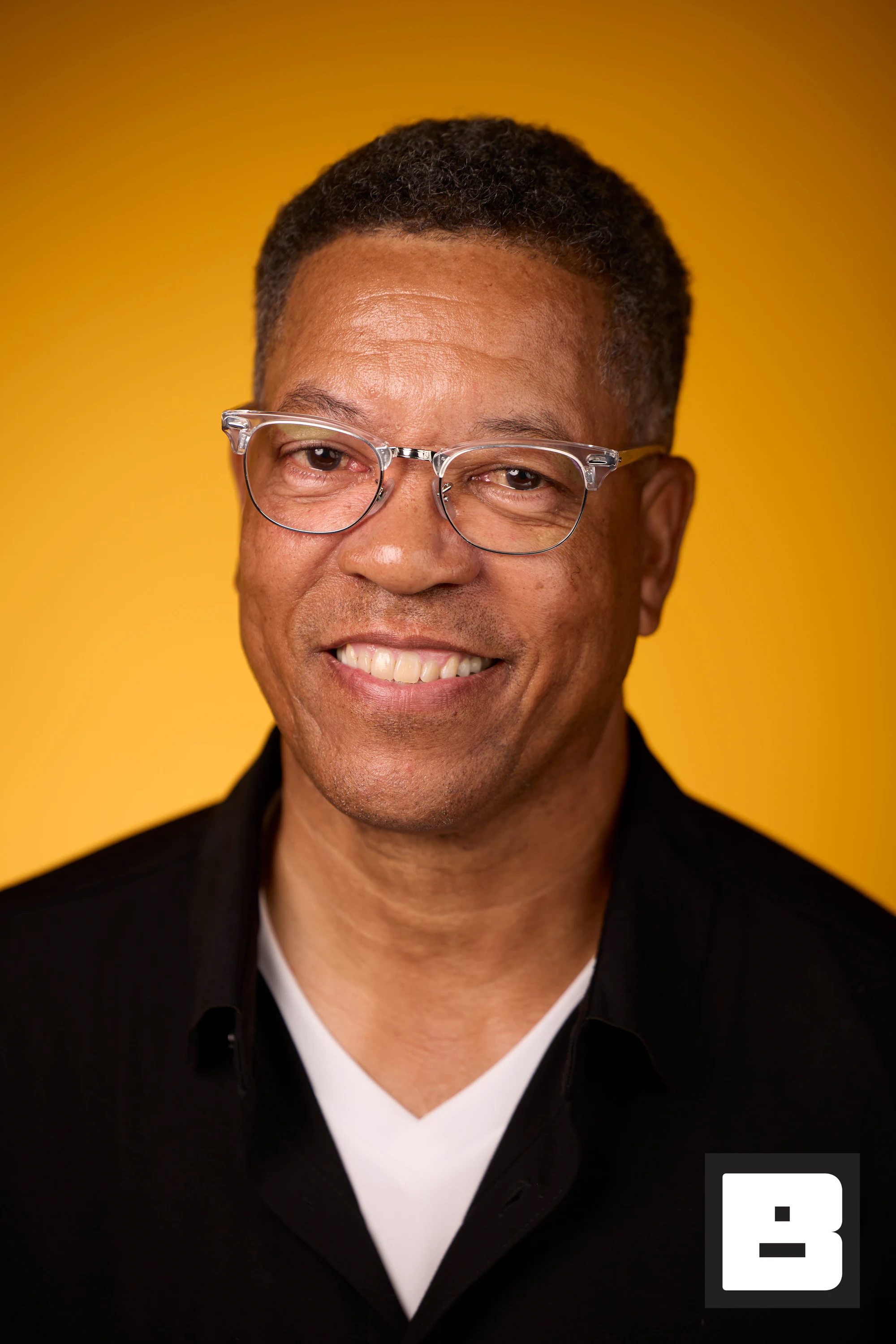 A headshot of a guest in clear-frame glasses and a black jacket at Black Tech Week 2025