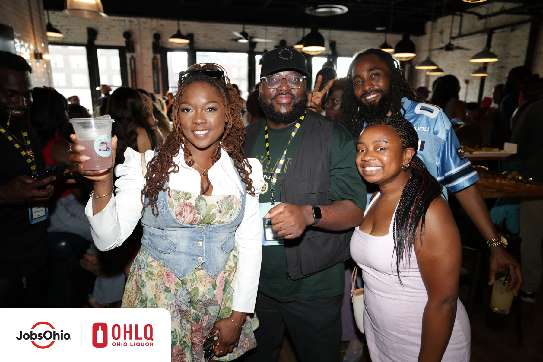 A group of guests at the closing reception, one raising a cup at Black Tech Week 2025