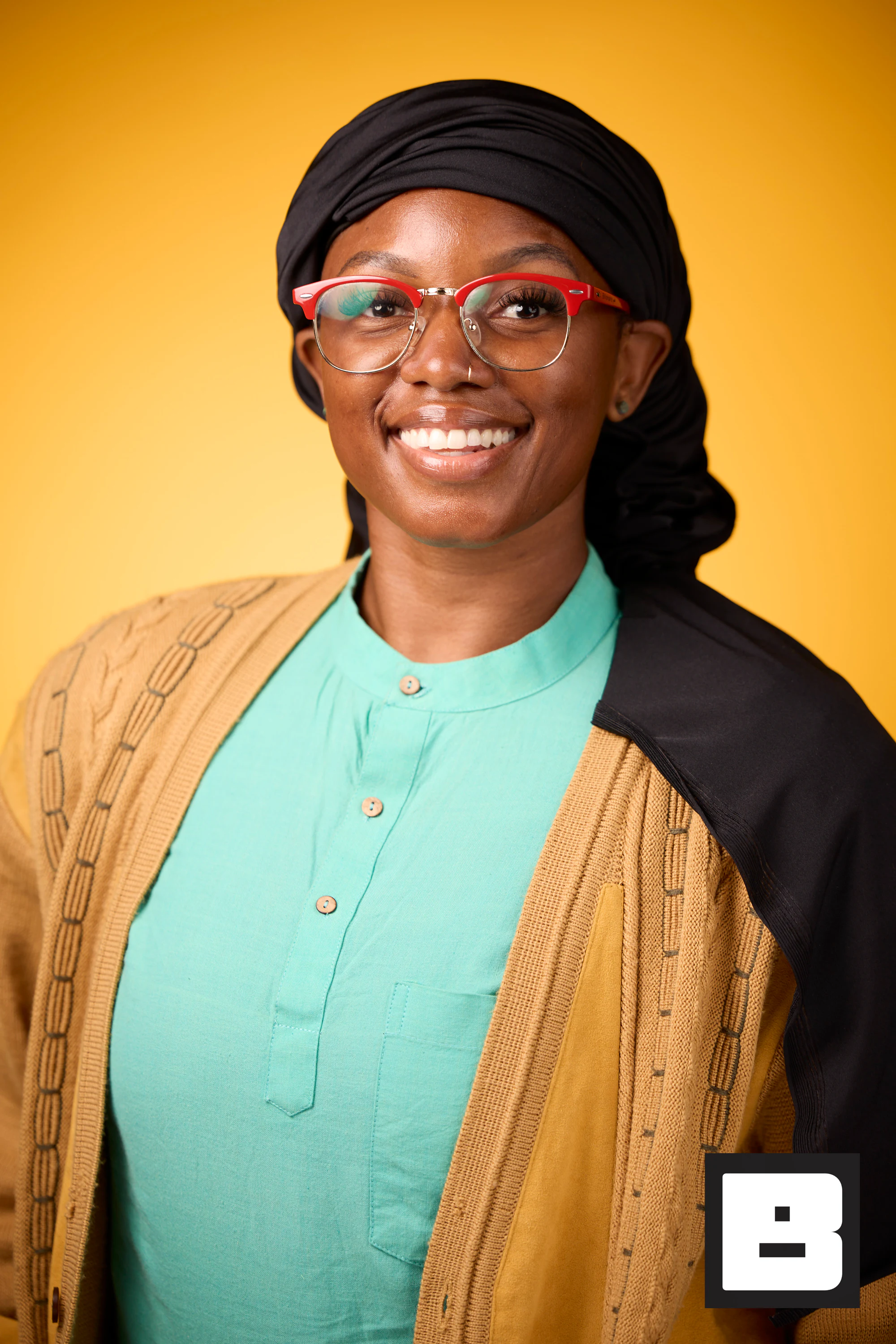 Teal and gold layers with red glasses, huge smile at P&G Confidence Lab at Black Tech Week