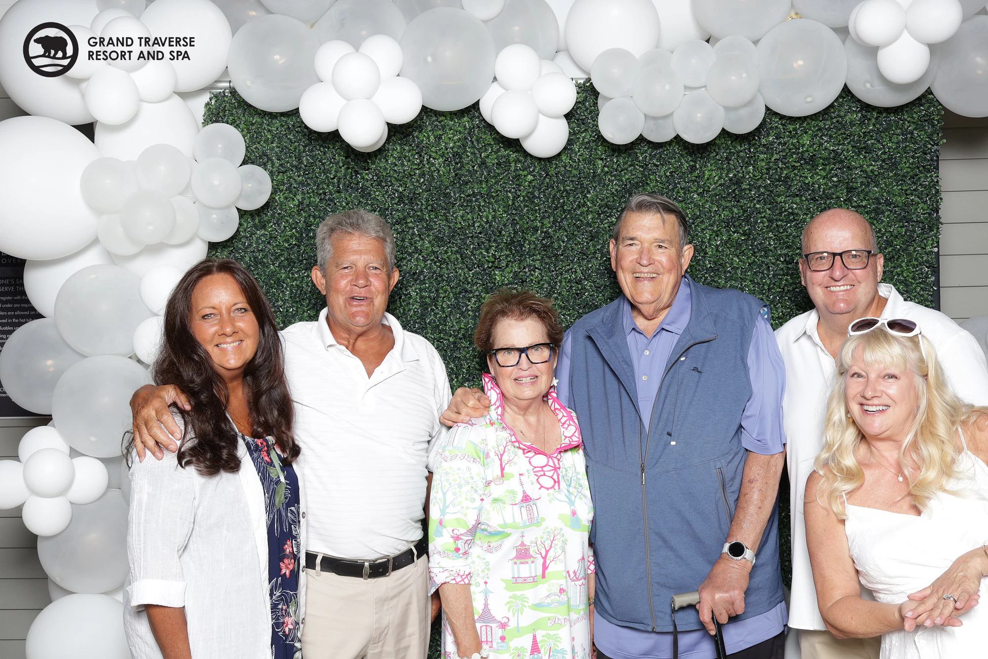 Six guests of different ages standing in a row, a man in a blue jacket with a cane in the middle at Blanco Night at Grand Traverse Resort