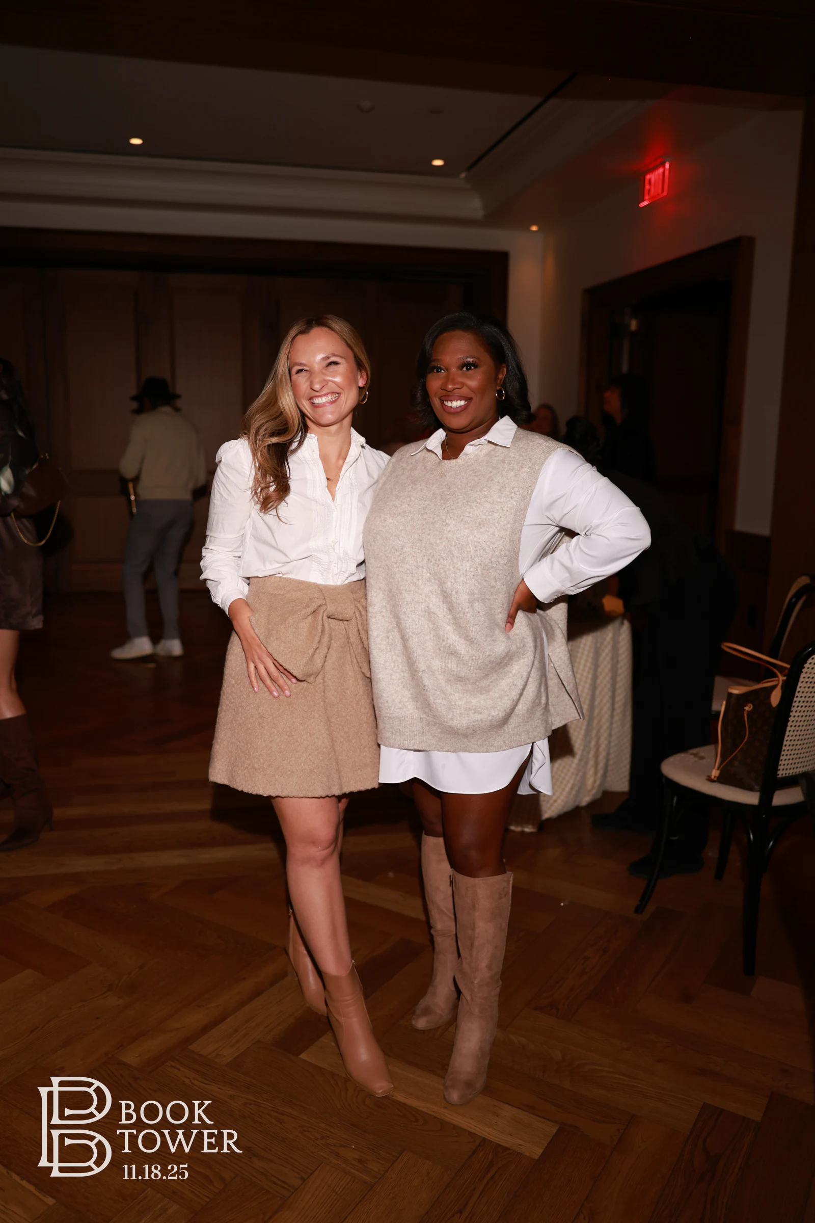 Two guests standing together on the herringbone floor at the Book Tower vendor event