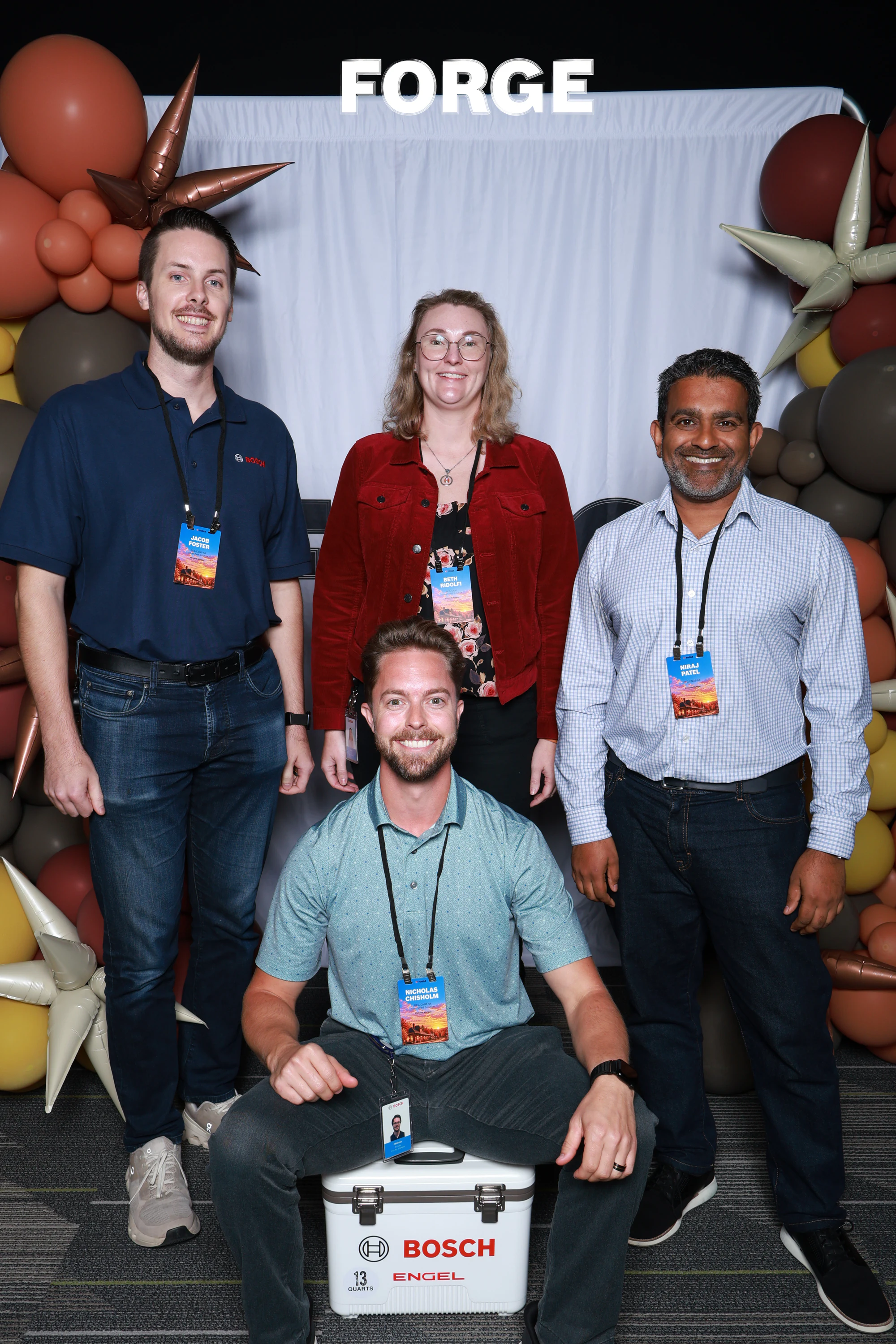 The four smiling, the man in front sitting on the cooler at Bosch FORGE 2026