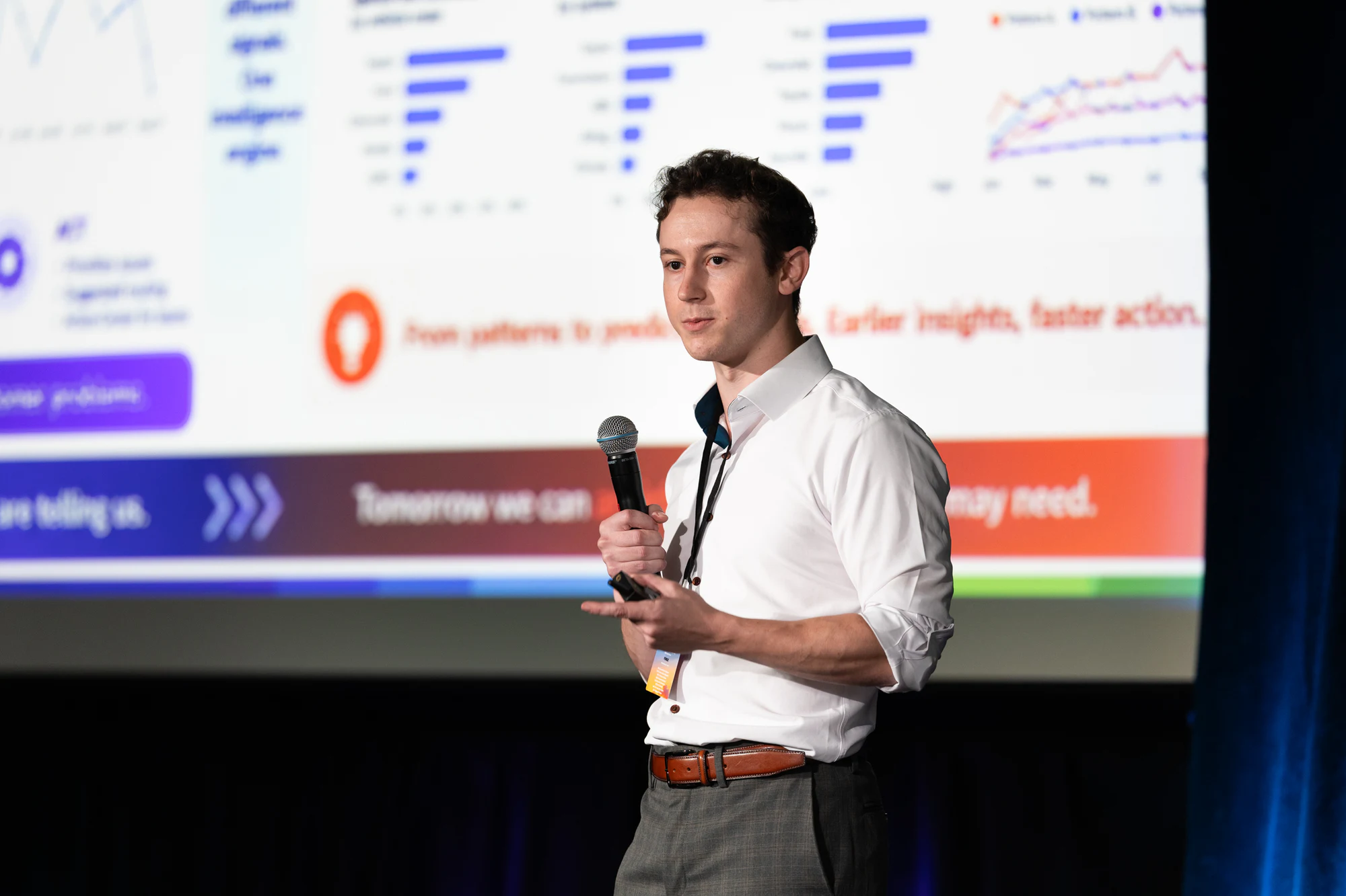 A presenter in a white shirt pitching in front of his slides at Bosch FORGE 2026