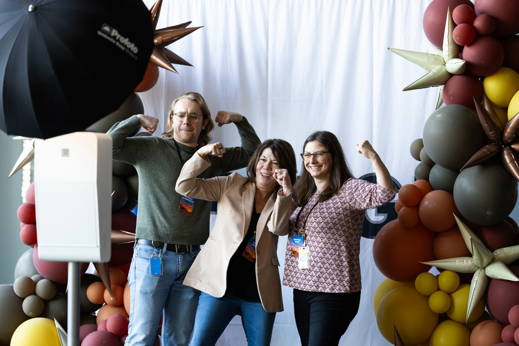 Three attendees flexing for the camera by the balloon wall at Bosch FORGE 2026