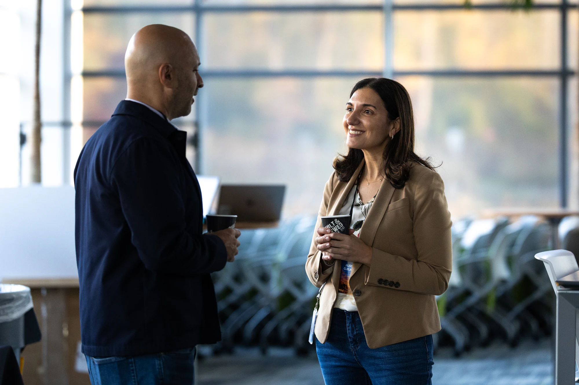 Two attendees talking by the windows between sessions at Bosch FORGE 2026