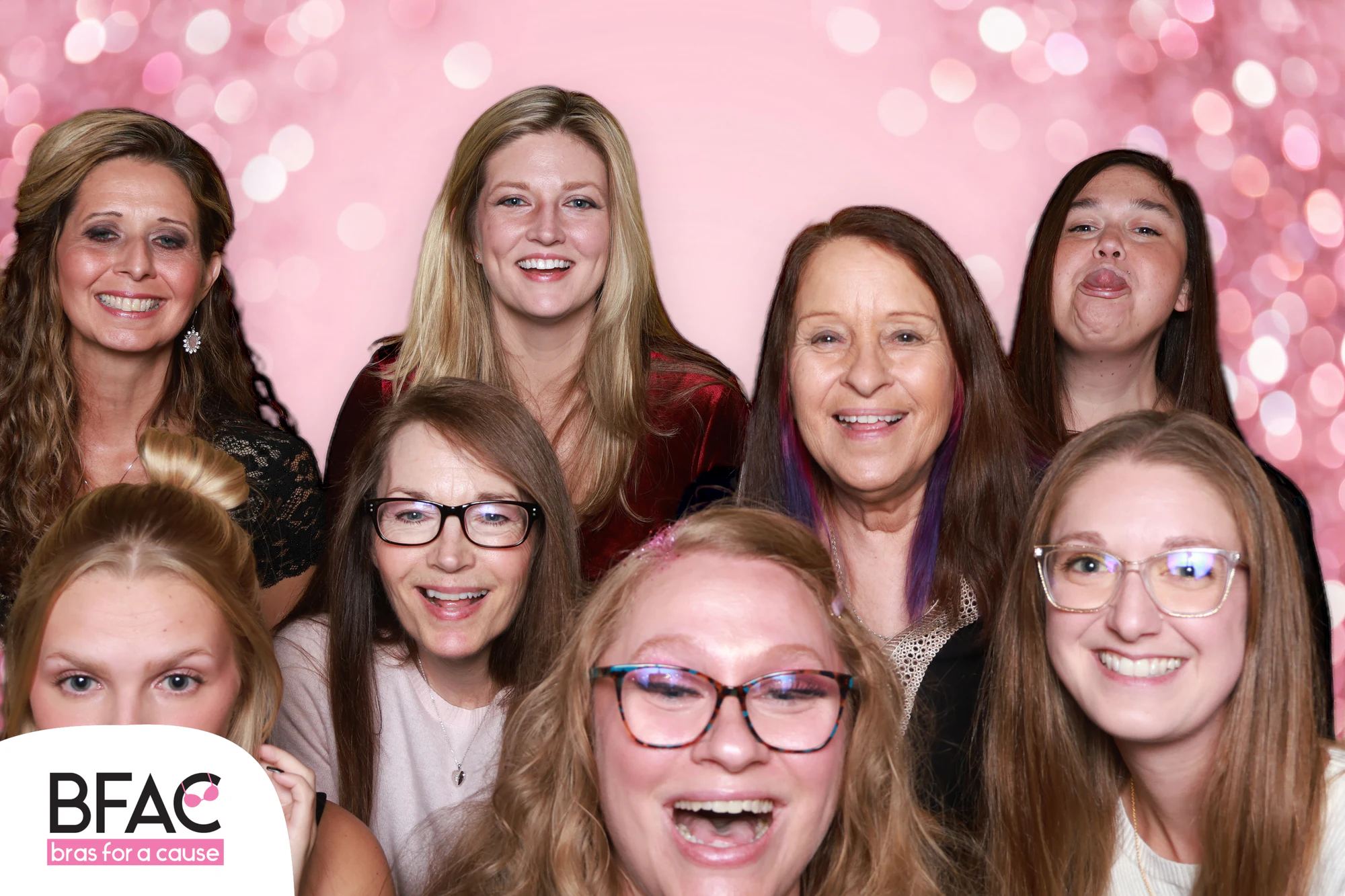 The eleven women laughing, one at the front with her mouth wide open at Bras for a Cause 2026