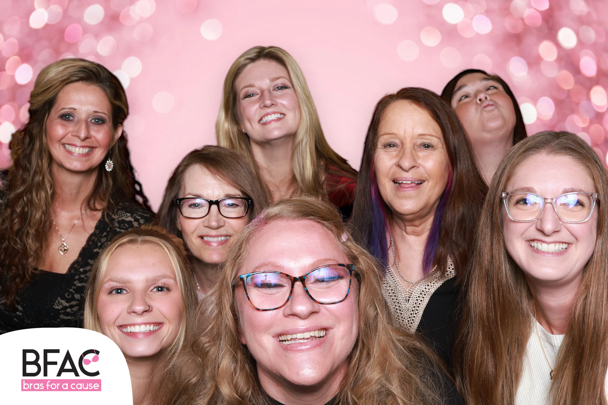 The eleven women smiling, the one at the front grinning wide at Bras for a Cause 2026
